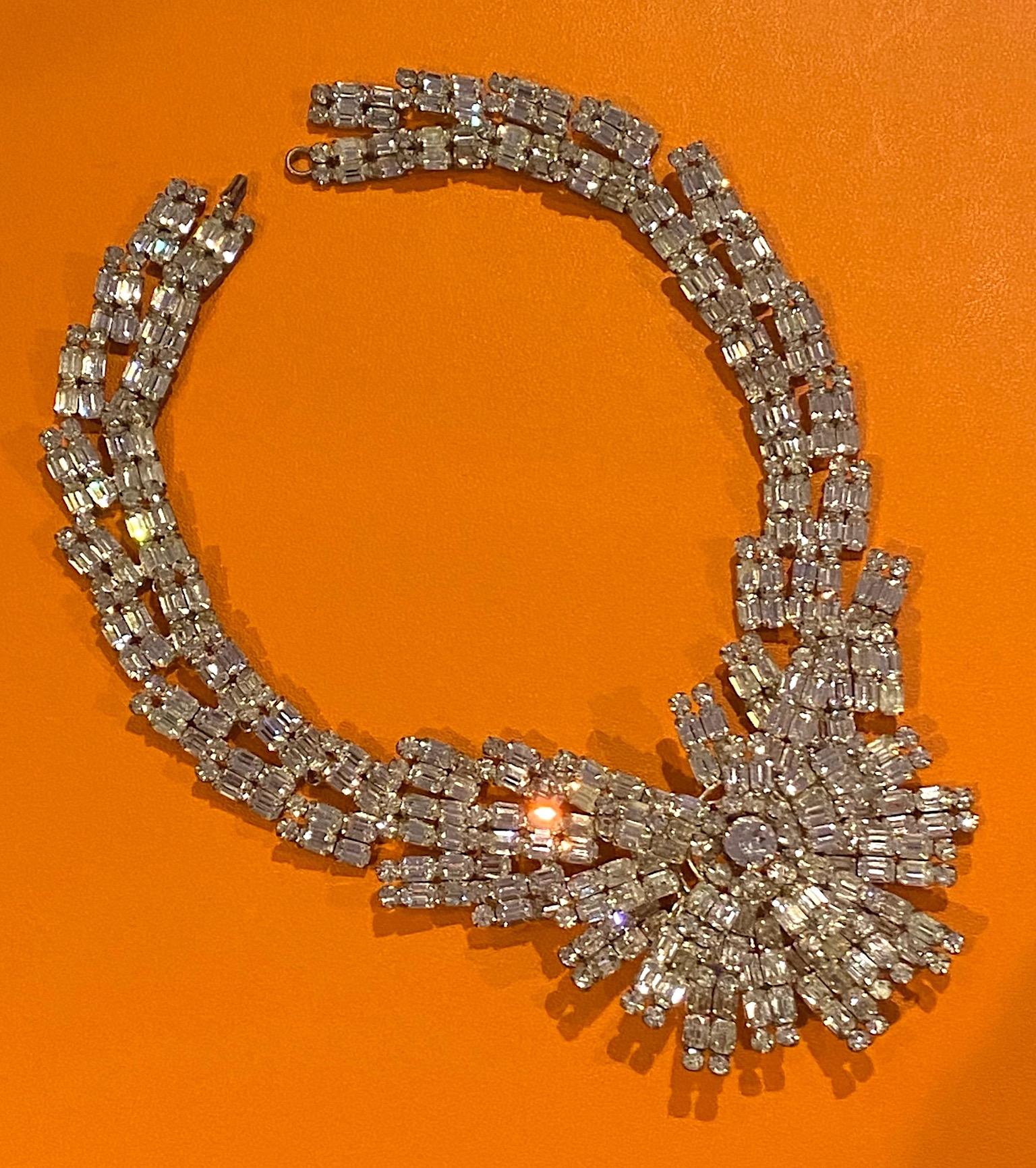 A spectacular and eye catching French emerald cut and round rhinestone starburst necklace from the mid 1950s to early 1960s complete with rhinestone extenders. All hand constructed in rhodium plate metal. Nine of the links, from the back forward