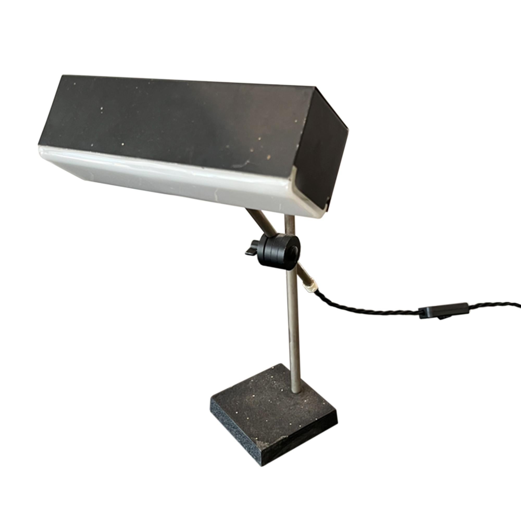 This adjustable desk lamp has a black painted textured steel base and a perspex shade.

A great addition to your study. We've had the light rewired with twisted black rope flex. 

Made in France in the 1960s.