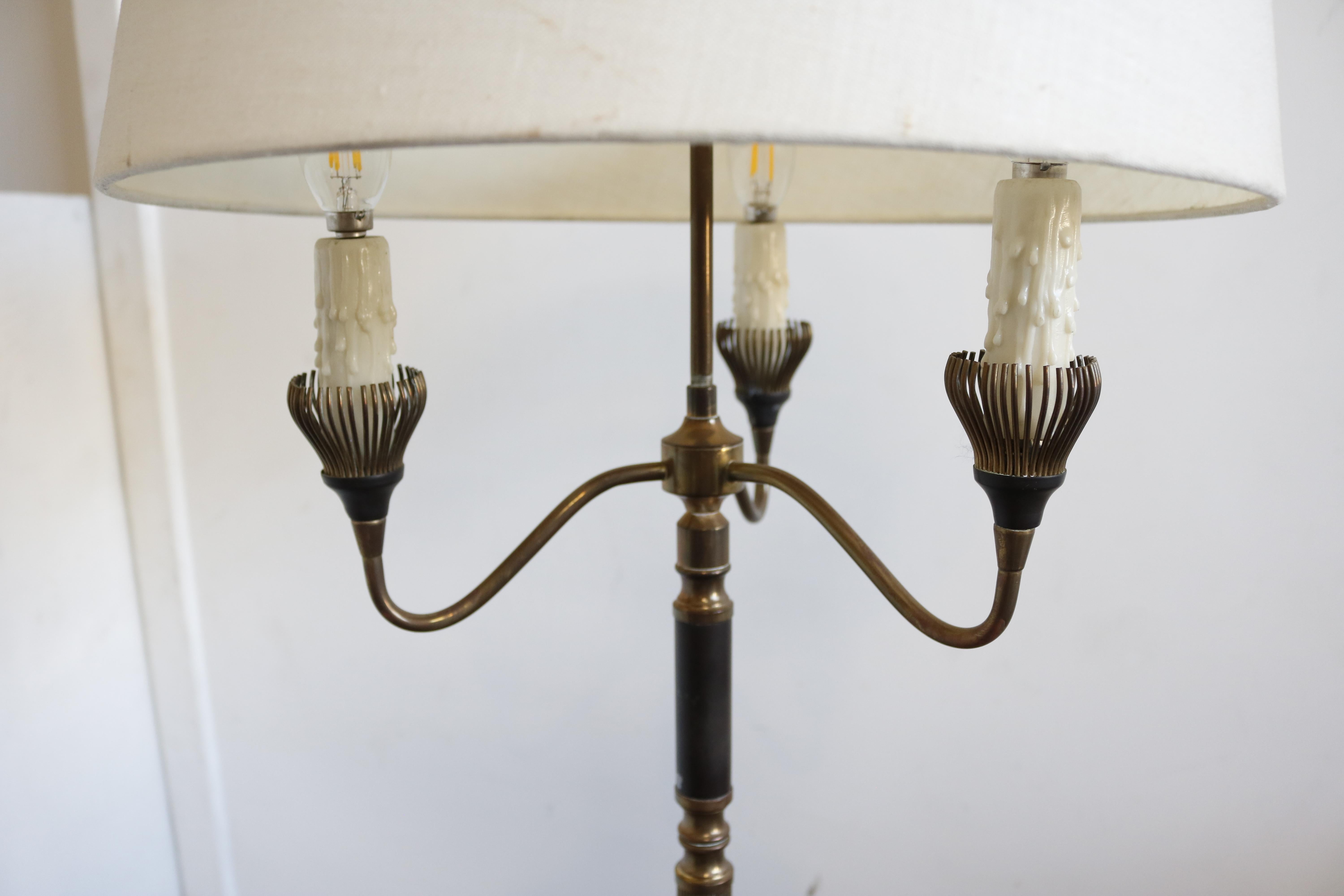 This three-armed French floor lamp from the 1950s features two different finishes as the brass is black patinated in some areas.