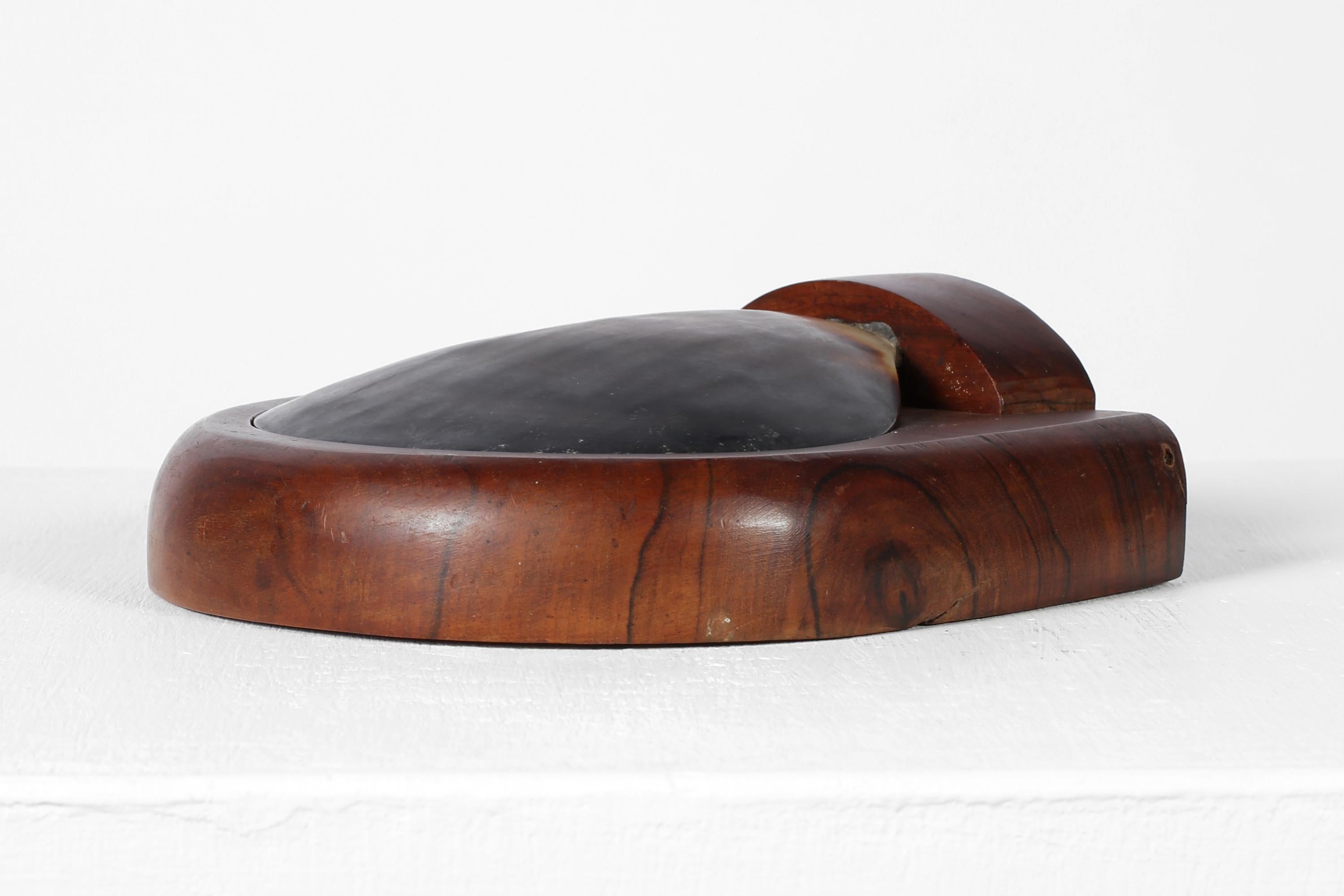 A chic, carved rosewood trinket or cigarette box with hinged mother-of-pearl shell lid in the manner of Alexandre Noll, unsigned. French, c. 1950s.