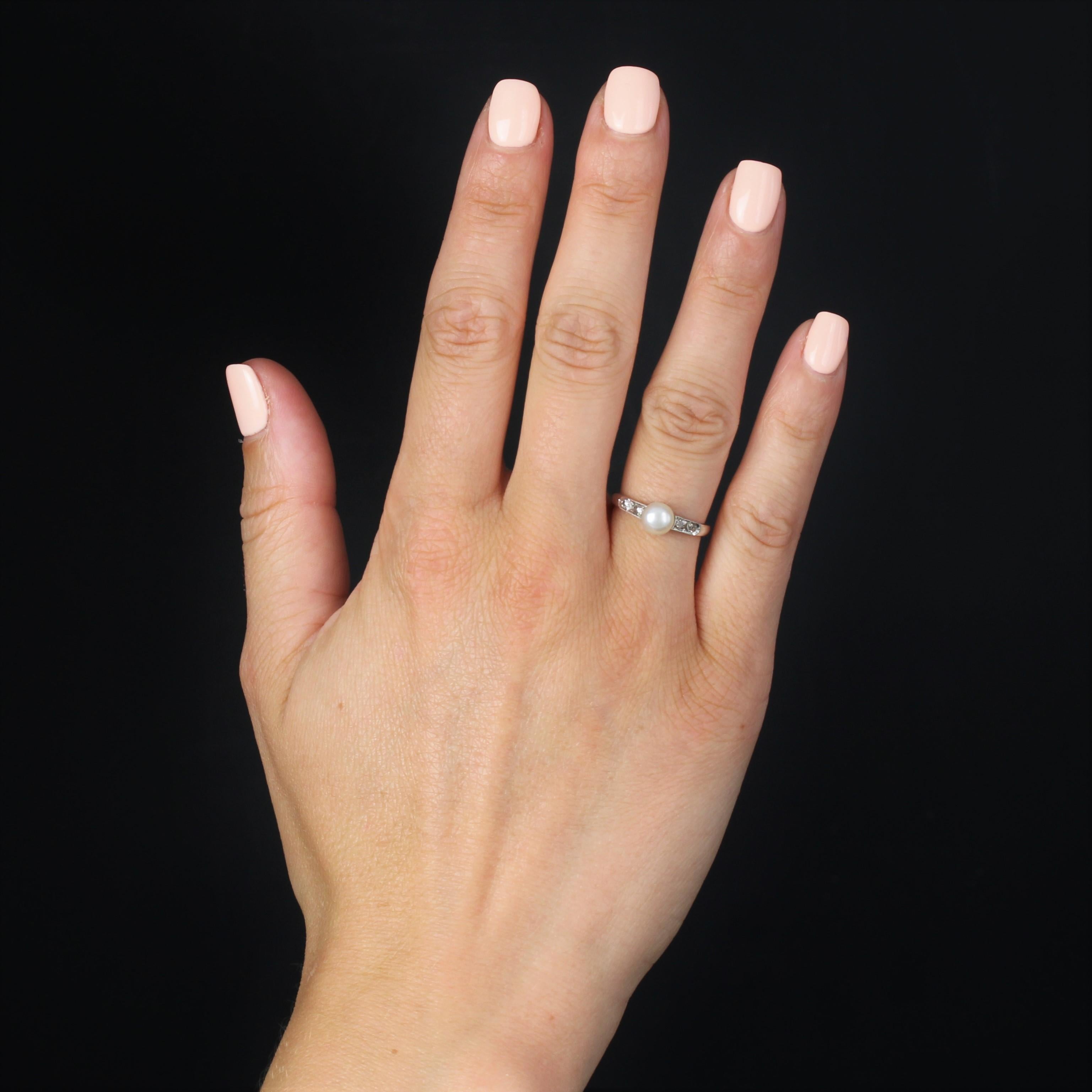Ring aus 18 Karat Weißgold, Adlerkopfpunze.
Ein entzückender antiker Ring mit einer cremeweißen Perlenknopf-Zuchtperle an der Spitze, flankiert von 2 x 2 Diamanten im Rosenschliff an beiden Seiten.
Durchmesser der Perle: ca. 5,5/6 mm.
Dicke: ca. 6,3