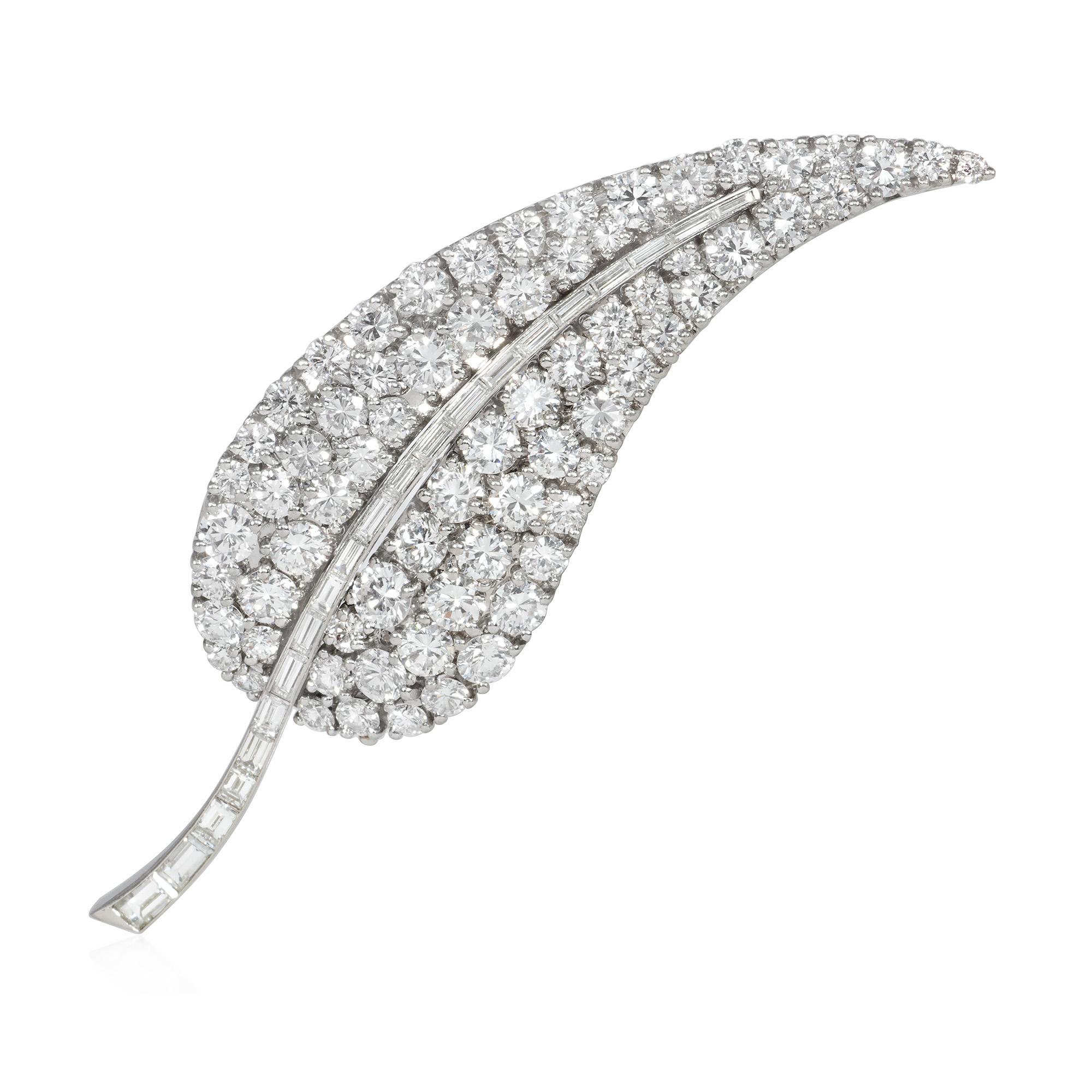 A mid-century diamond brooch in the form of a stylized leaf with three interchangeable spine inserts in sapphires, rubies, and diamonds, in platinum.  France.  Atw diamonds 6.25 cts.  See photo of complementary clip earrings, also with