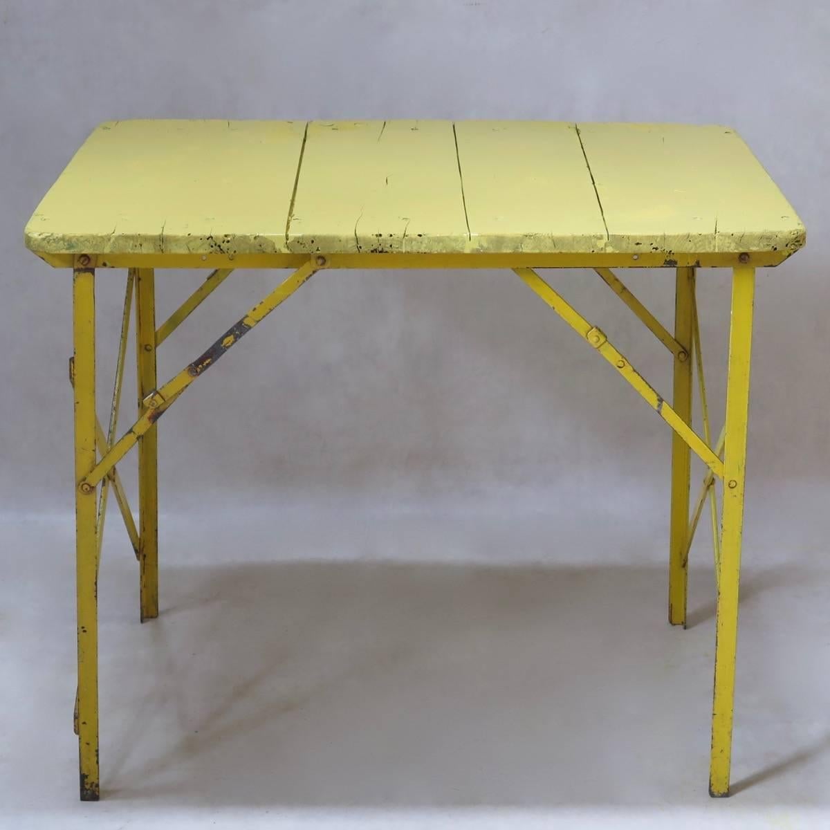 Fun, and very sturdy and well-built picnic tables. The iron bases fold beneath the wooden tops, making them easy to store, and pull out when necessary. (Ten available).