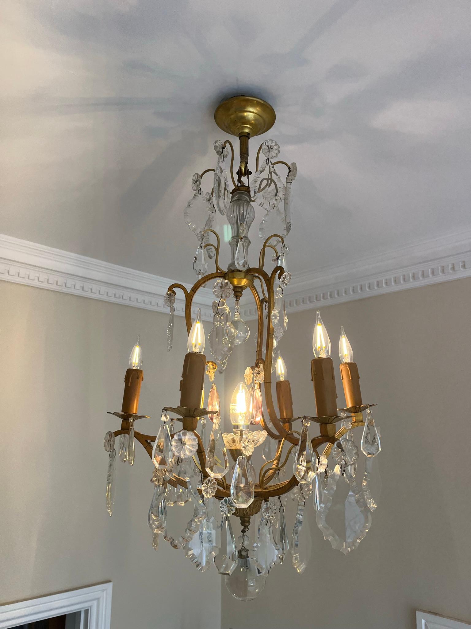 A very elegant glass and gilt metal French chandelier in the style of Maison Jansen. Glass drops and gilt metal.