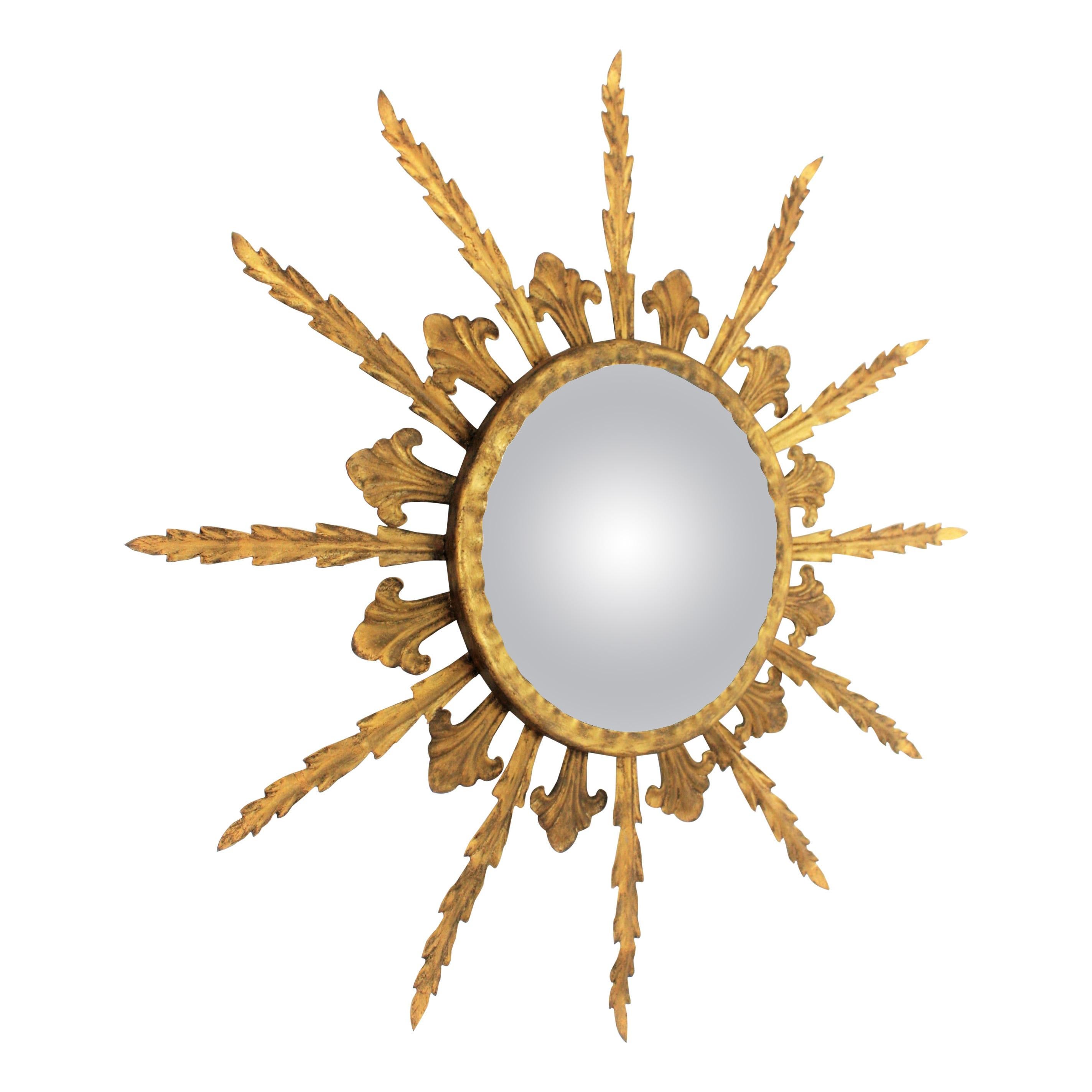Hollywood Regency Sunburst Convex Mirror in Gilt Metal, France, 1950s
Eye-catching gilt iron Hollywood Regency convex sunburst mirror with leafed frame and gold leaf finish. France, 1950s.
This mirror has a beautiful aged patina and it is