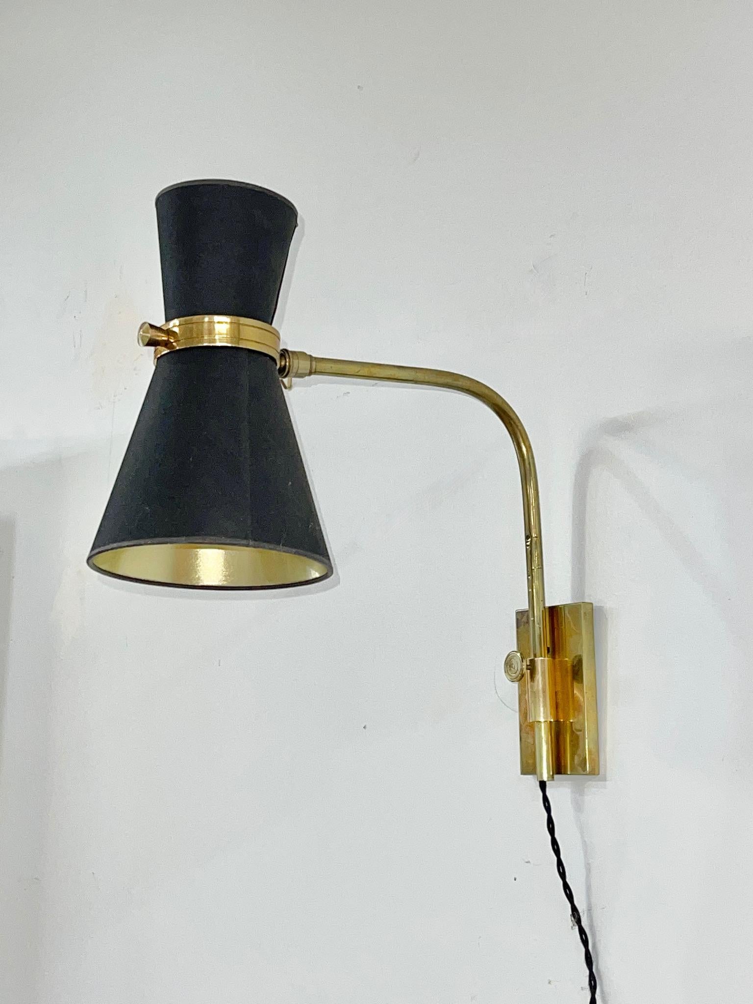 High quality French 1950's wall mounted swing arm lamp by Maison Lunel.
Brass curved arm swings 180 degrees and is height adjustable by adjusting the knob on the stem.
Diabolo double cone light articulates with knurled swivel joint.
Brass box