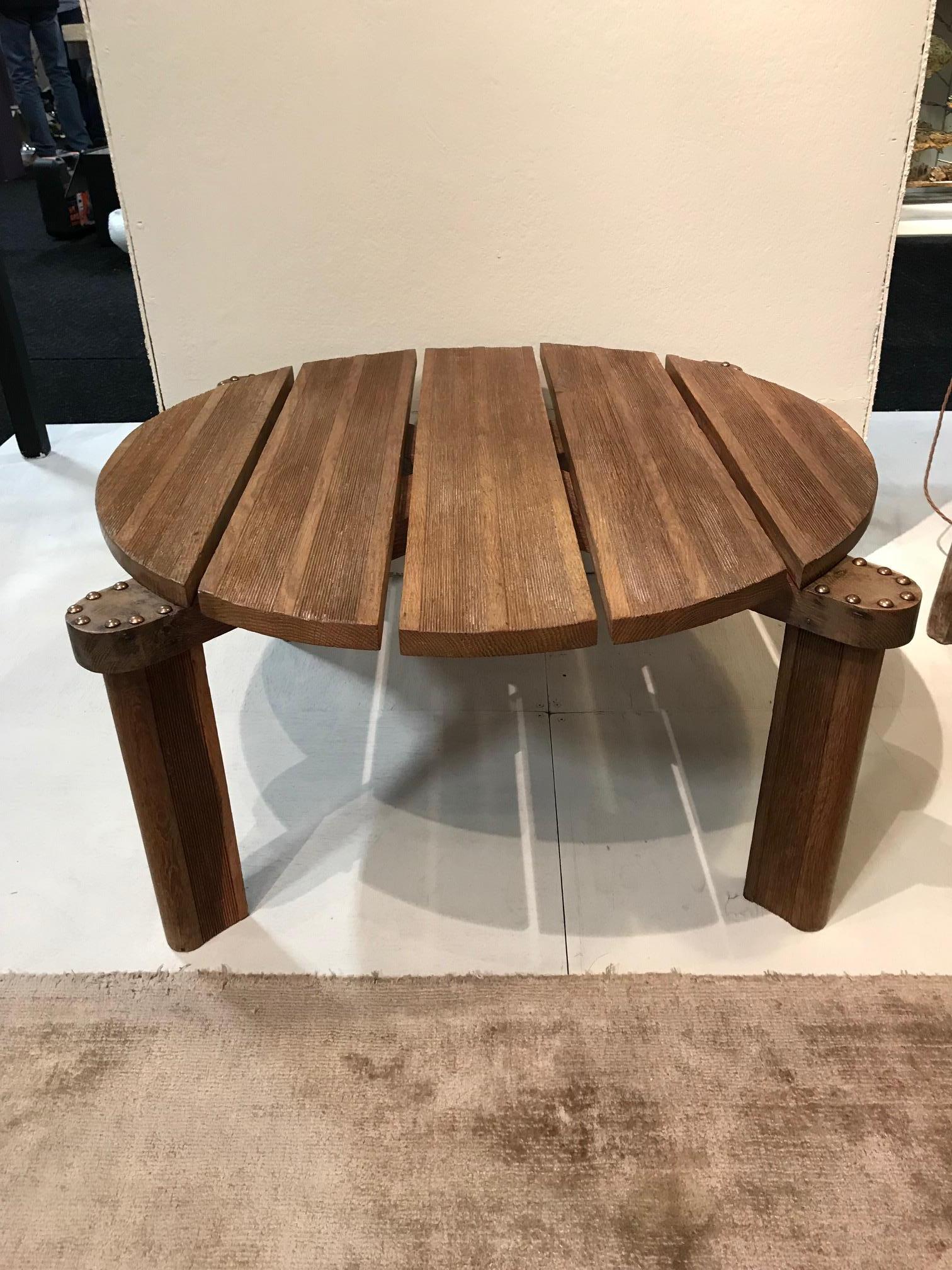 A French 1950s oak circular grooved coffee table of exceptional build quality and design. Studded detail which is replaced.