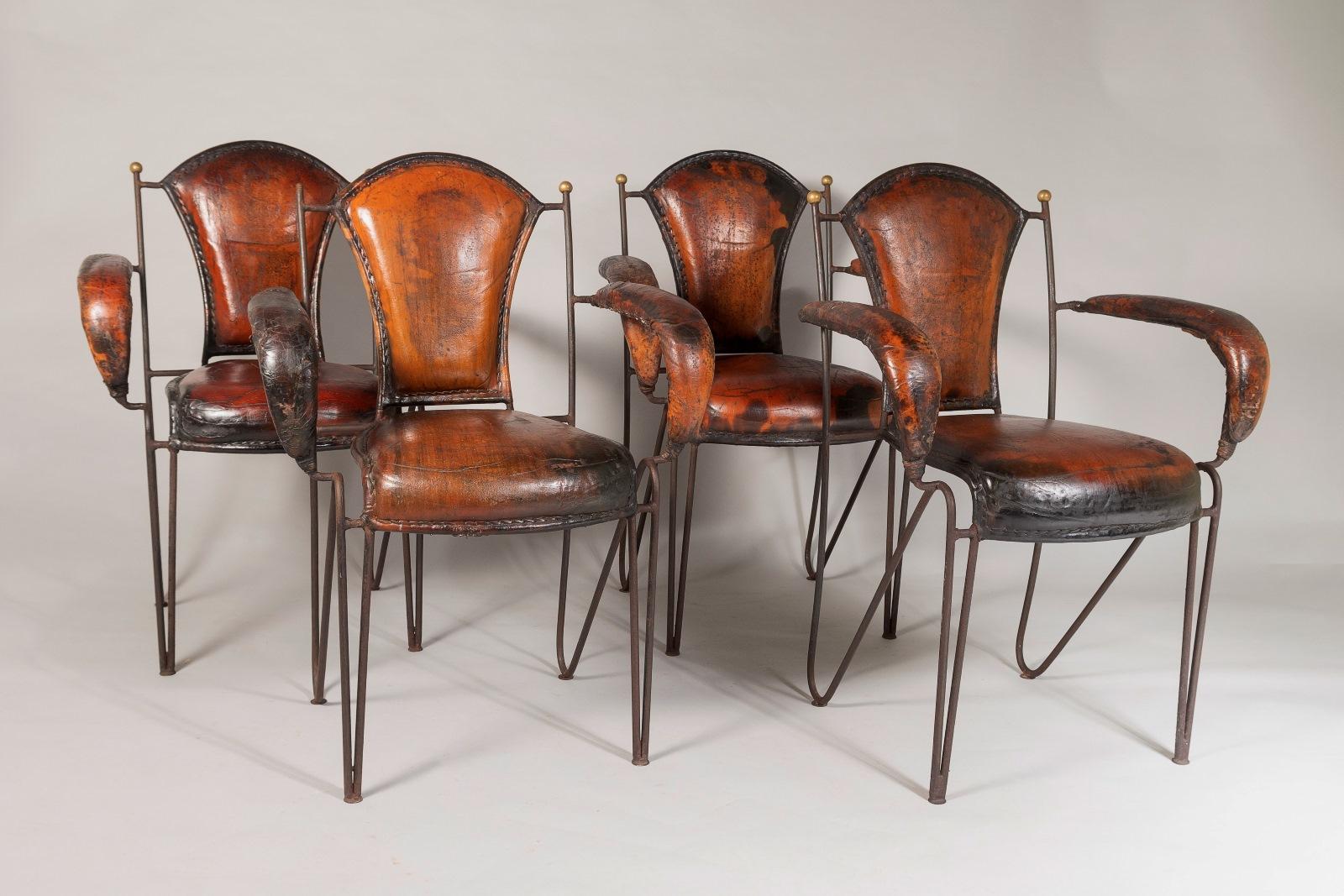 A set of four designer chairs by Jacques Adnet, heavy iron frame and leather stitched armchairs.
Adnet was an Art Deco modernist designer and although these Chairs were designed later in his career, they still have an Art Deco feel to them and a