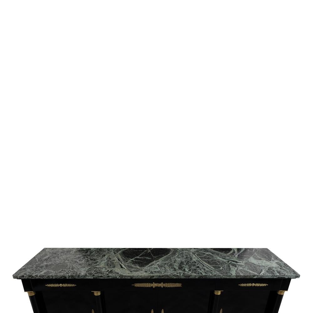 Mahogany credenza Janses style buffet in an ebonized finish with beautiful dark green and white colored marble. This grand buffet has four top drawers with intricate brass details, four doors with brass keyholes, and three adjustable shelves. Lock