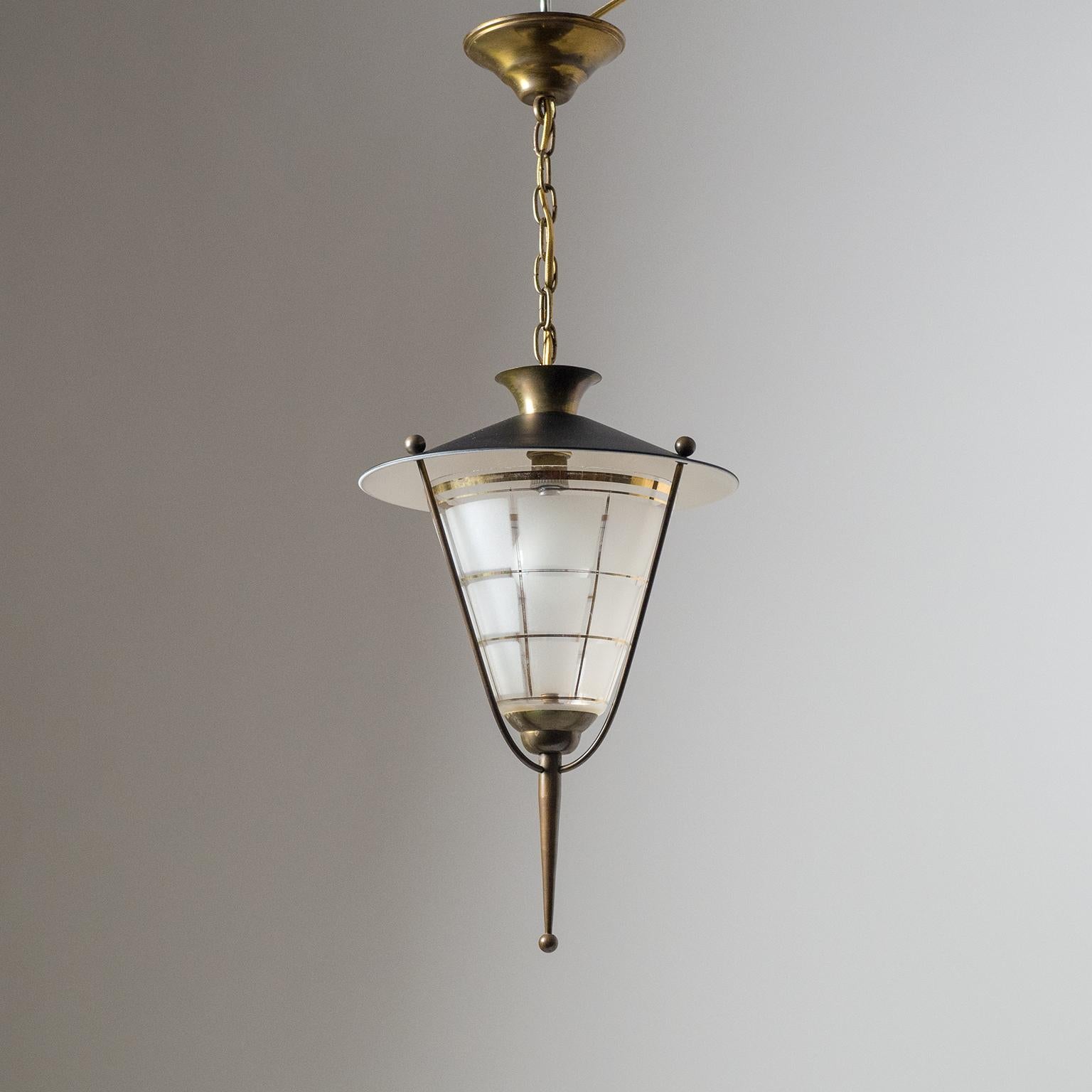 Classic French midcentury lantern or pendant. Black and white lacquered shade and a glass diffuser with geometric frosting and gold paint accents are held by brass hardware. Very nice condition with patina on the brass parts and some wear to the