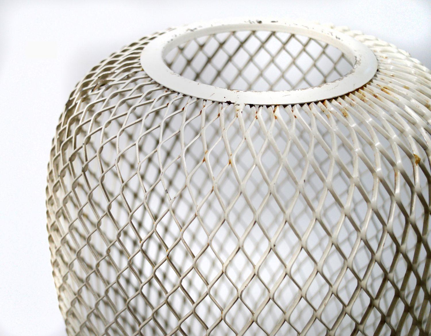 A large French open metal worked mesh vase in cream enamel dating from the 1950s in the style of Mathieu Matégot.
Of classical plum shape but modernist in design the vase rests on a raised circular plinth creating a harmonious balance between form,