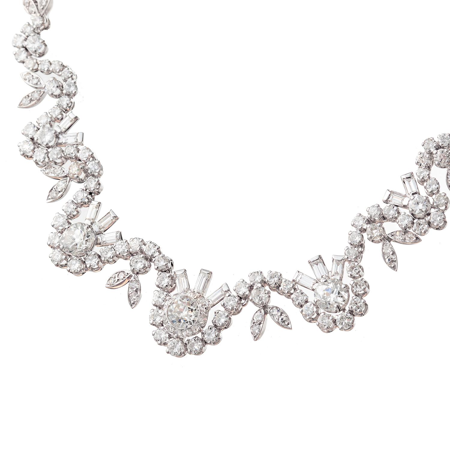 Fine handmade 18k white gold flower and leaf motif collar necklace, featuring round, baguette, old mine and old European-cut diamonds.  Diamonds altogether weighing approximately 22.00 total carats.  Stamped with French gold assay marks.