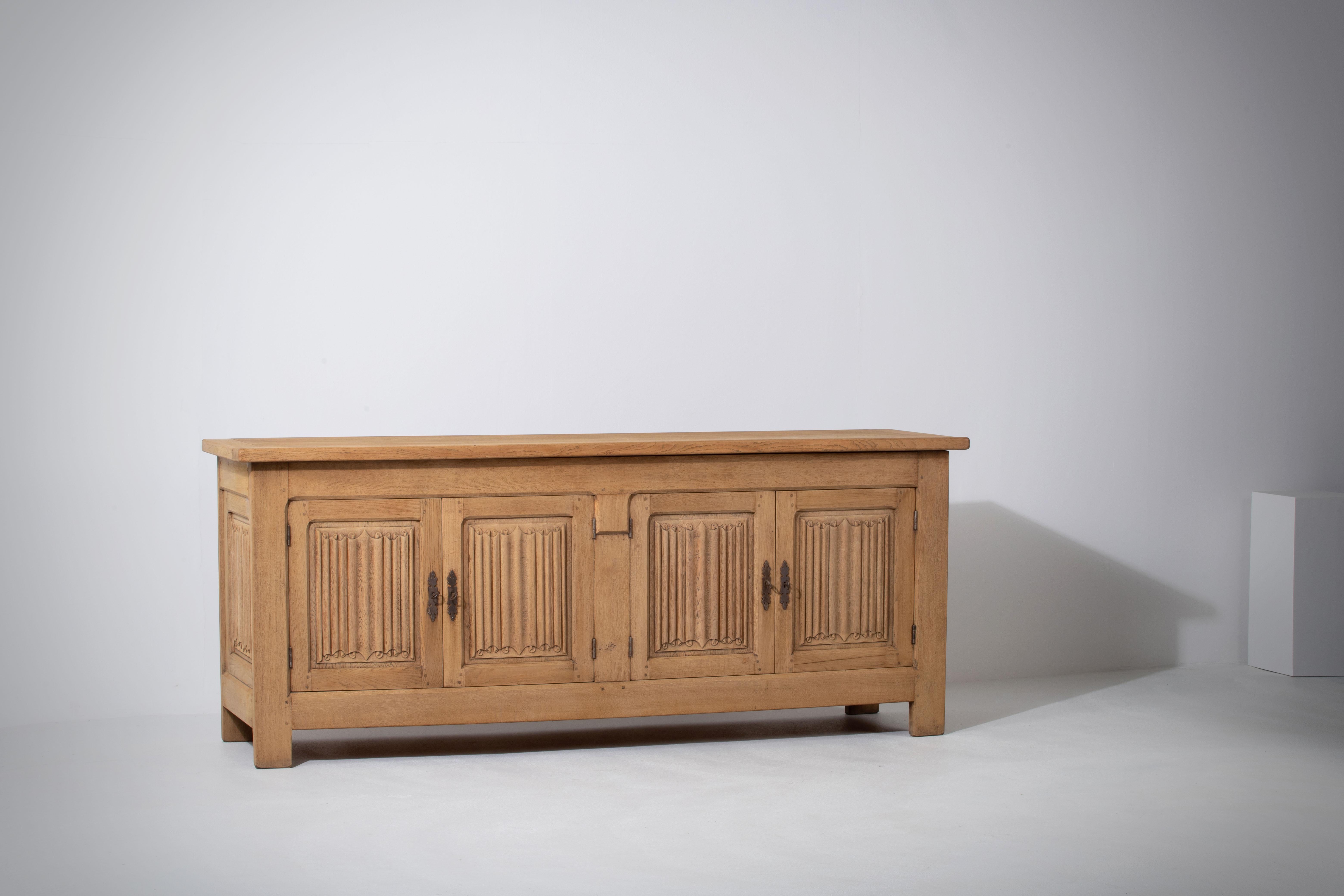 This oak sideboard has a charming story to match its elegant design. It was discovered in a small house in the South Alps region of France, which had been left untouched since the 1950s. The house was adorned with typical Alps decor and tapestry,