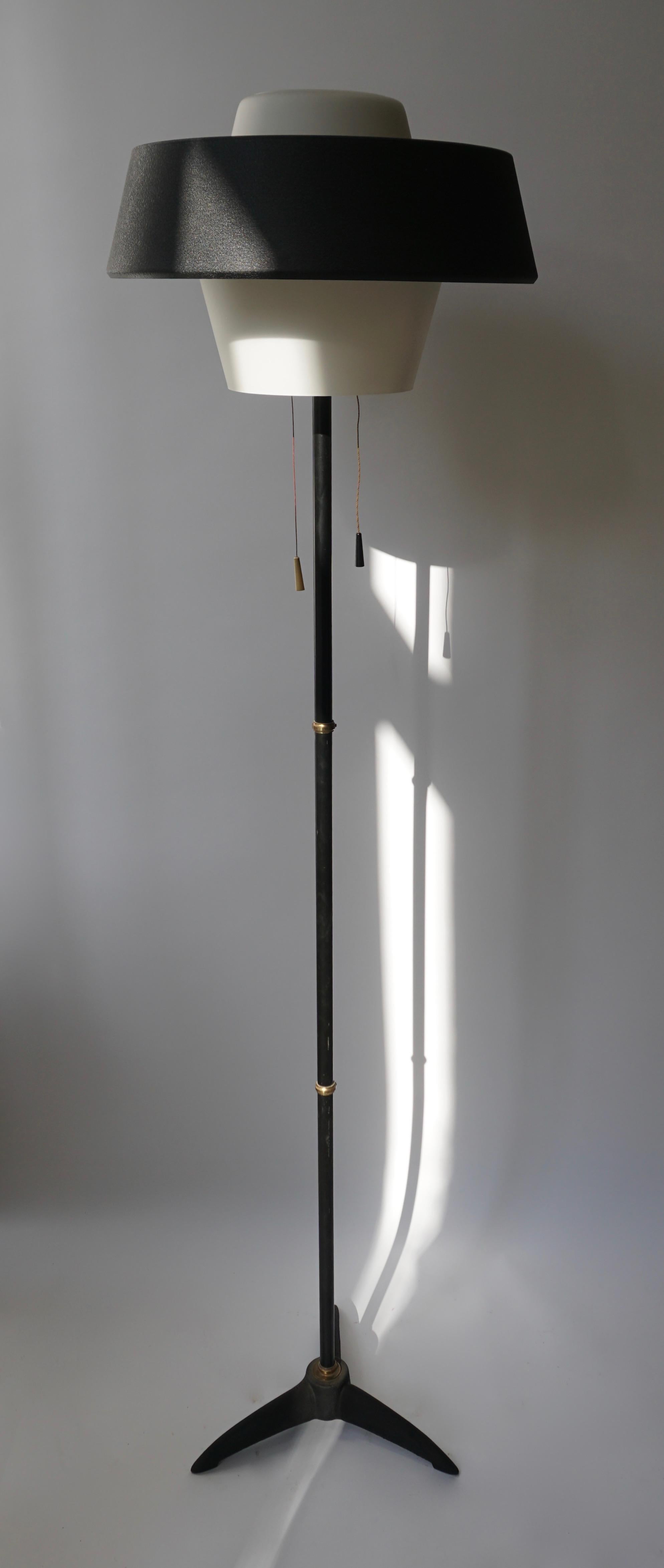 Louis Kalff 1950s floor lamp produced by Philips Eindhoven, The Netherlands.The hint of an exotic African motif and topped with an opaline glass shade head' surrounded by a black hood.

Louis Kalff NX 109 Floor Lamp

Materials: Black cast iron