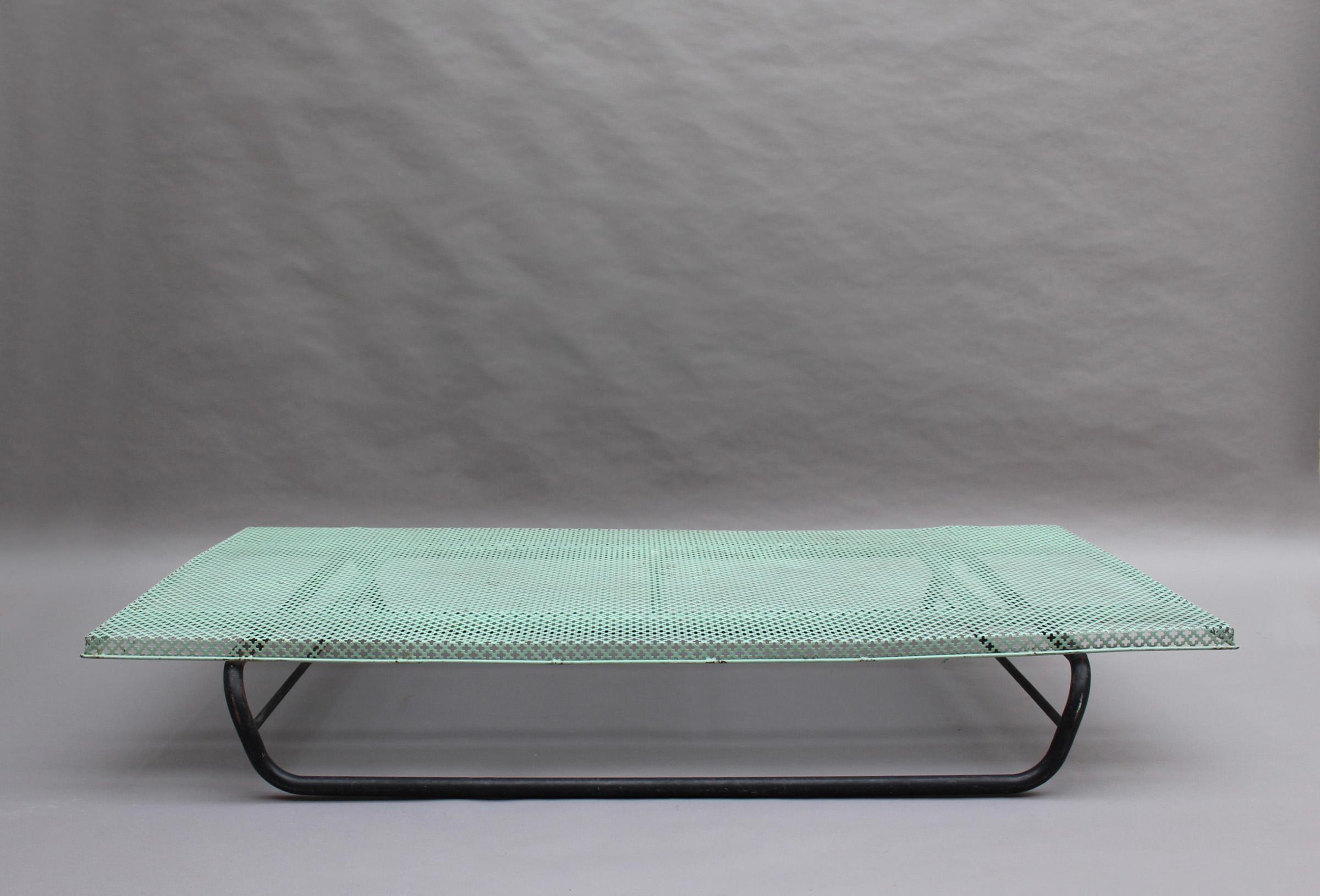 A French midcentury perforated metal coffee table in the manner of Mathieu Matégot, with a tubular metal base.
 