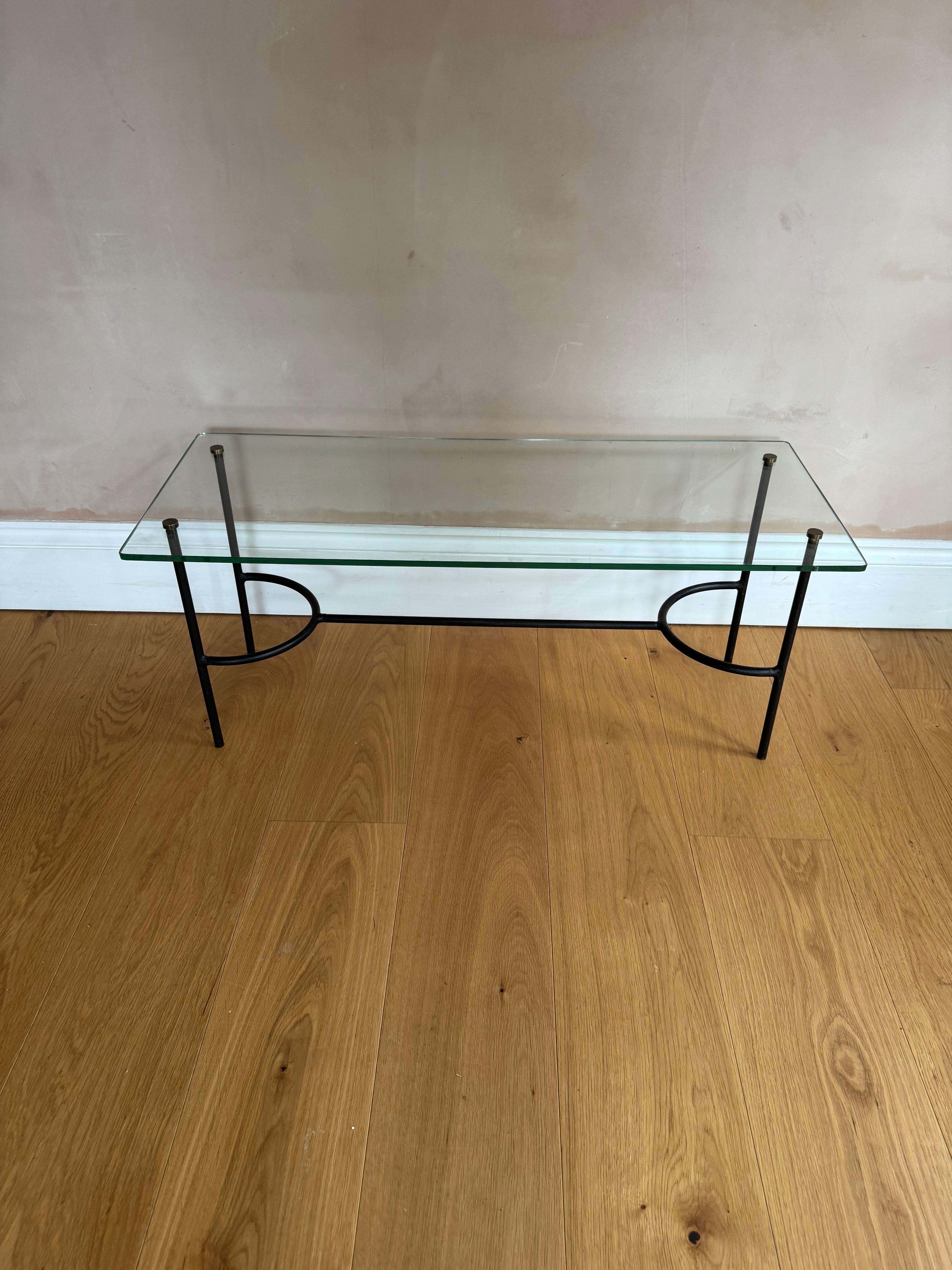 A small French black iron and glass coffee table attributed to Pierre Guariche. 