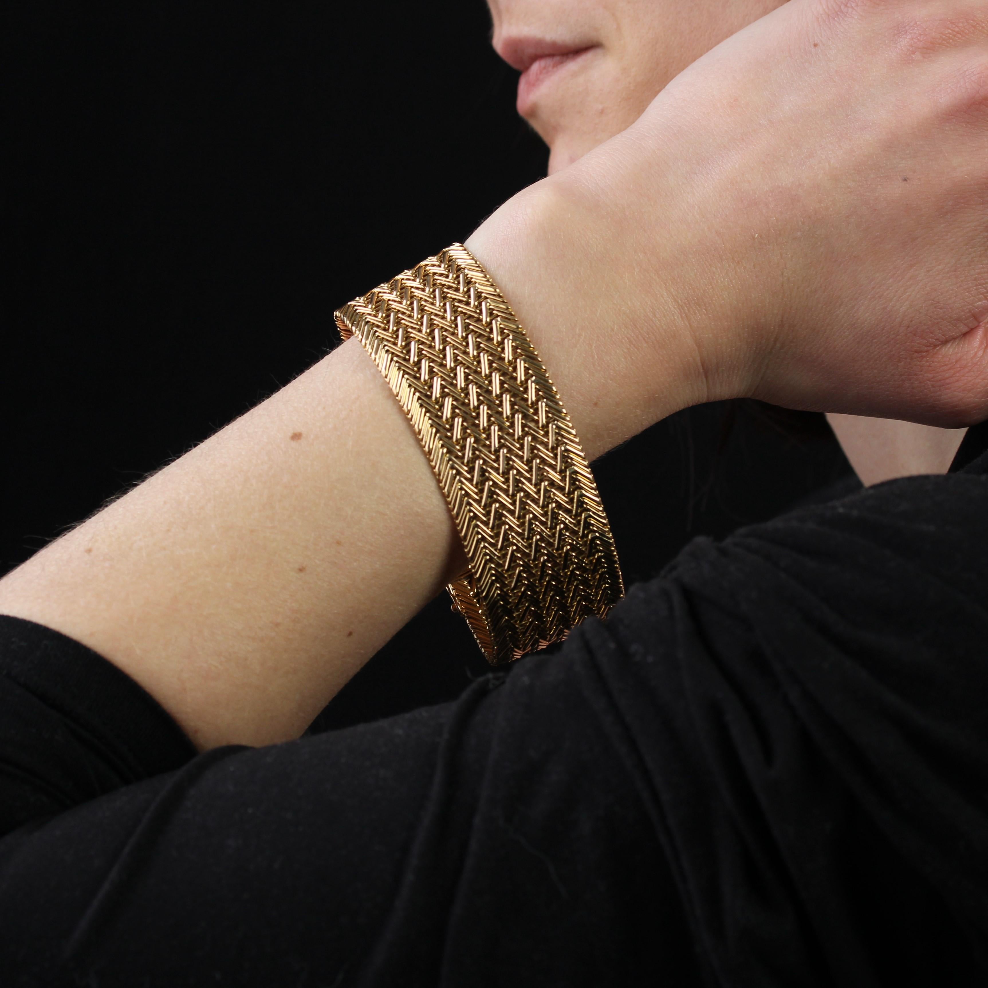 Bracelet in 18 karat yellow gold, eagle and rhinoceros heads hallmarks.
An important and supple vintage bracelet, it is formed of a flat mesh like a twill over its entire length. The clasp is a large ratchet with two 8 safety catches.
Length : 21 cm