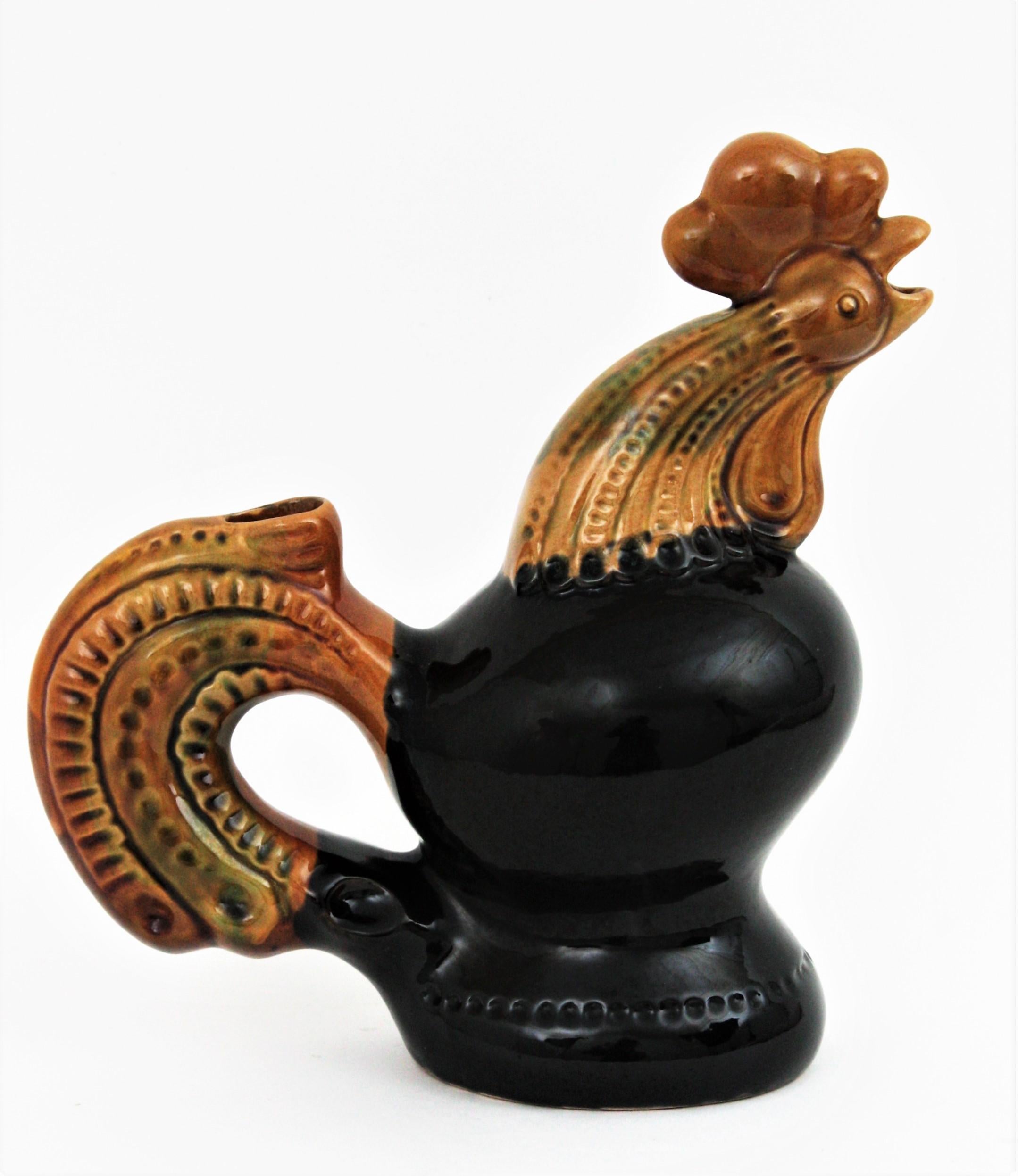 Eye-catching black and amber Majolica ceramic rooster jug / pitcher, France, 1950s.
A cool accent to any kitchen or to be user as serving pitcher. Lovely as a part of a ceramics collection displayed in a cabinet.
Mark from the manufacturer