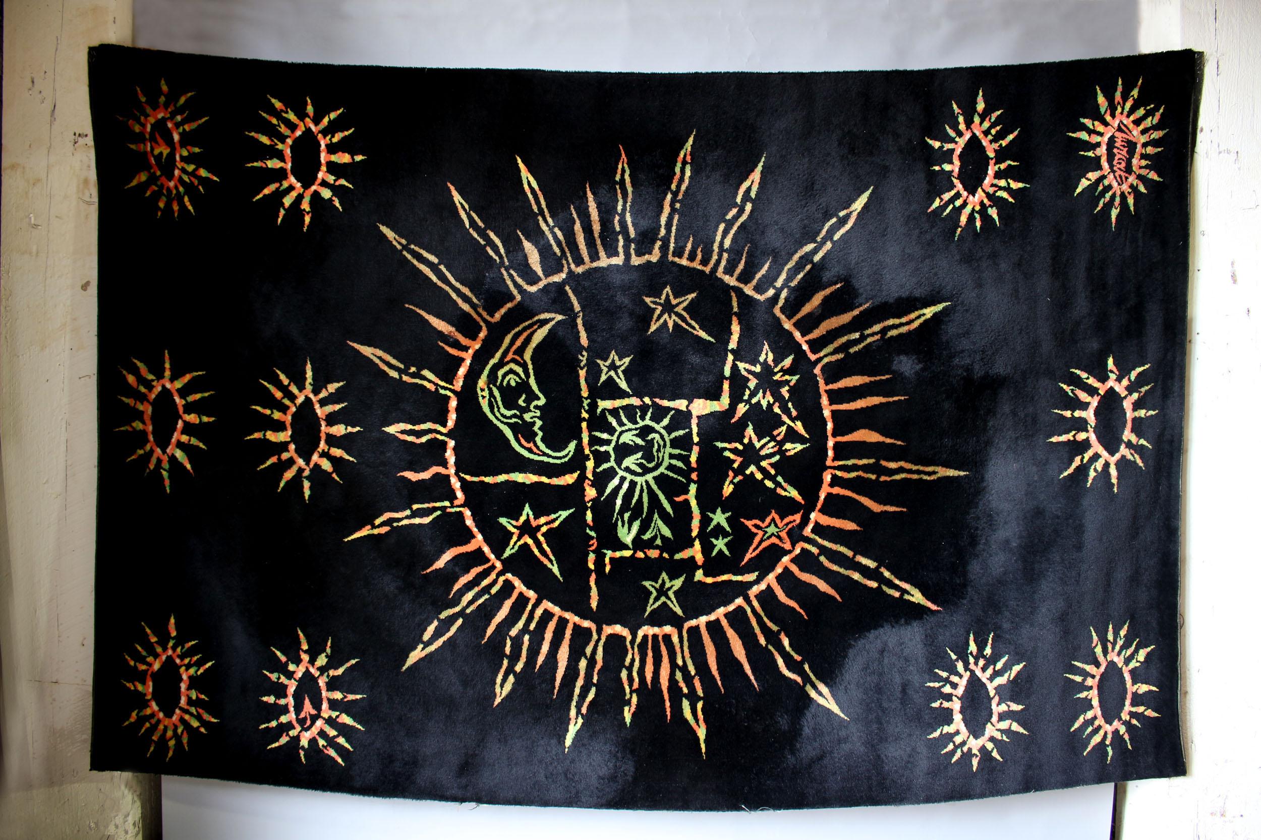 A fine French 1950s rectangular black background wool rug with colorful sun, moon and stars motifs by Jean Lurcat.
Signed.