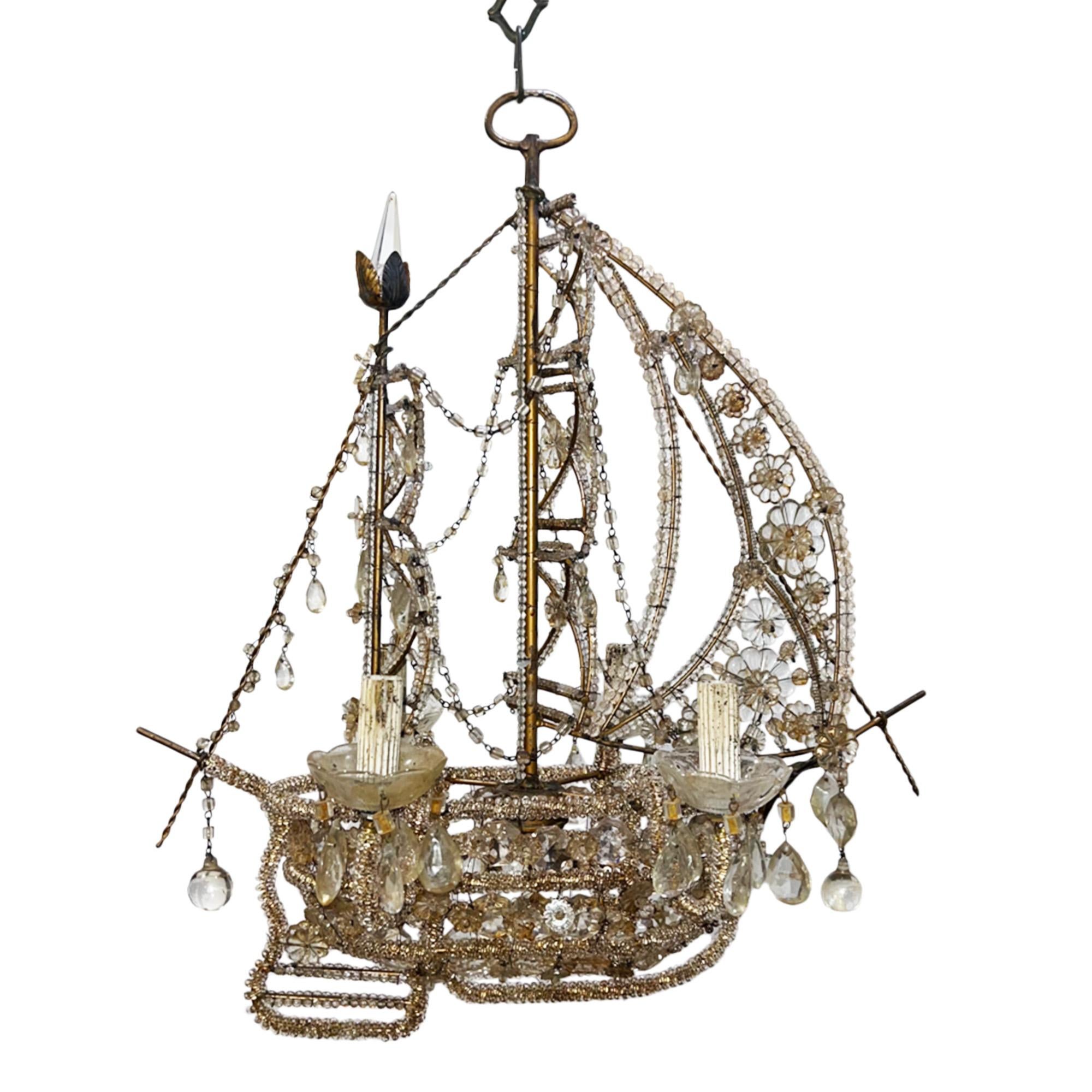 This very decorative chandelier was made in France in the 1950s. It has beautiful beaded detail to create the hull, rigging and sails, with an interesting crystal in the crow's nest. Take a look at all our pictures to see the intricate construction.