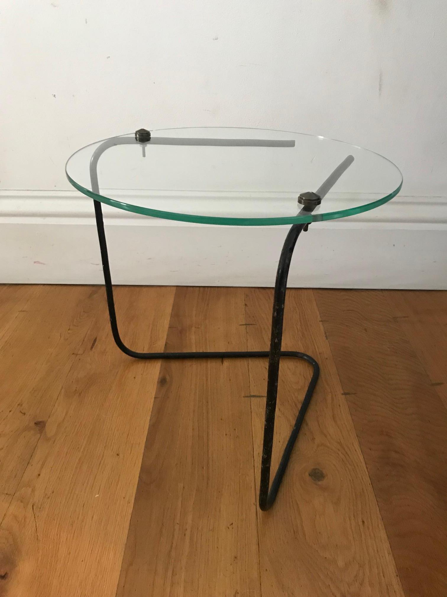 A French 1950s small glass (replaced) and black metal with brass stud detail side table.