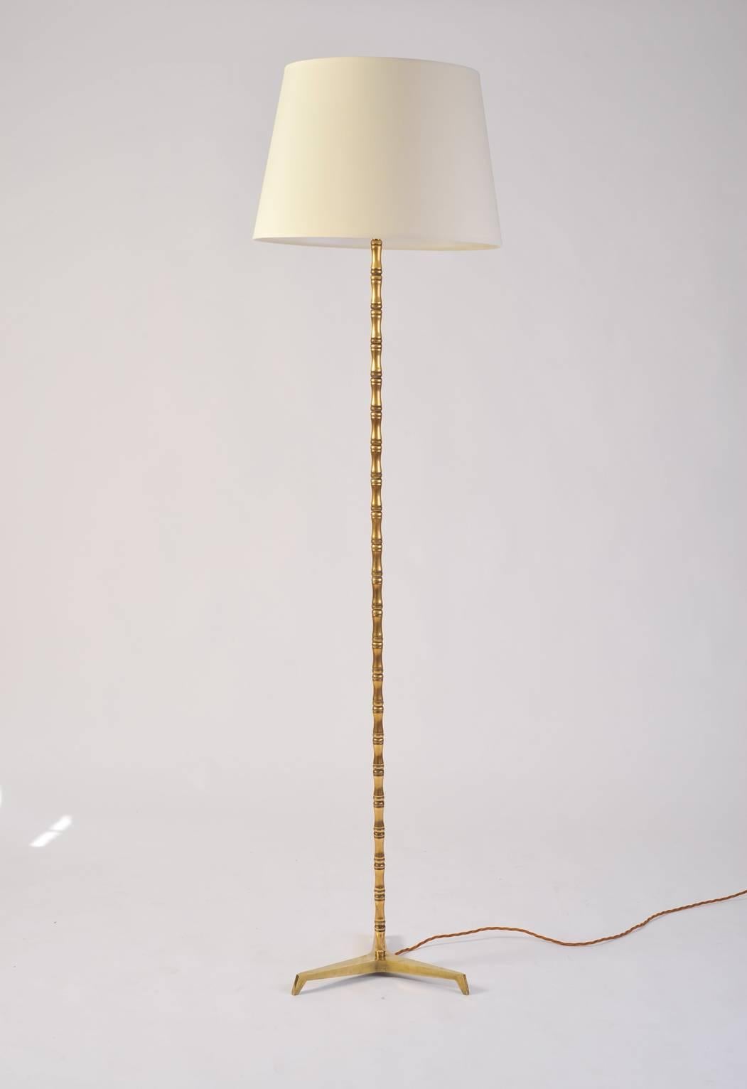 A tall stylised bamboo floor lamp.
France, circa 1950.