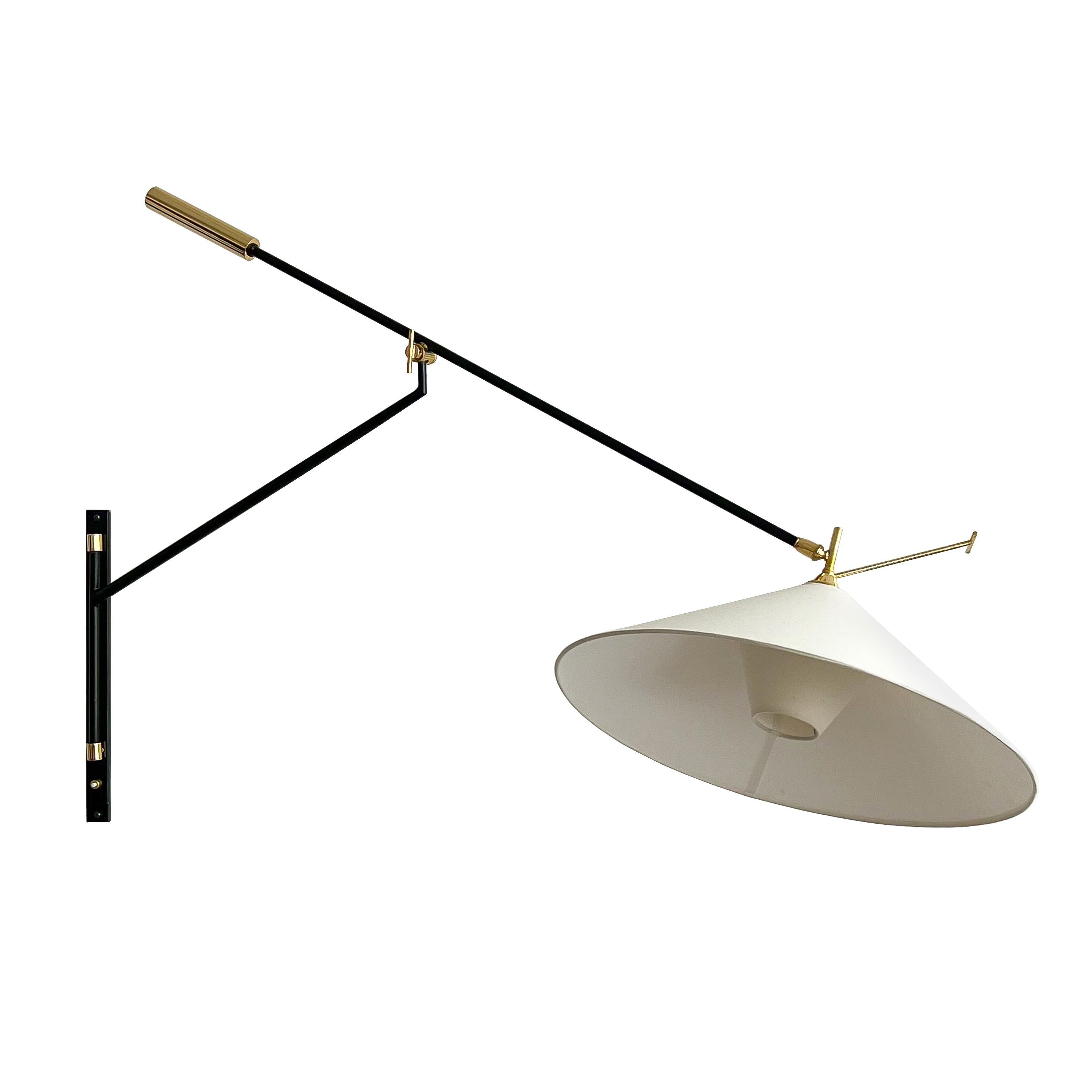 French 1950s swing arm articulating wall sconces by Maison Lunel. Only one is currently available, priced individually. Large wall mounted sconces in black lacquered metal, brass and newly fabricated linen shades. Cylindrical solid brass weighted
