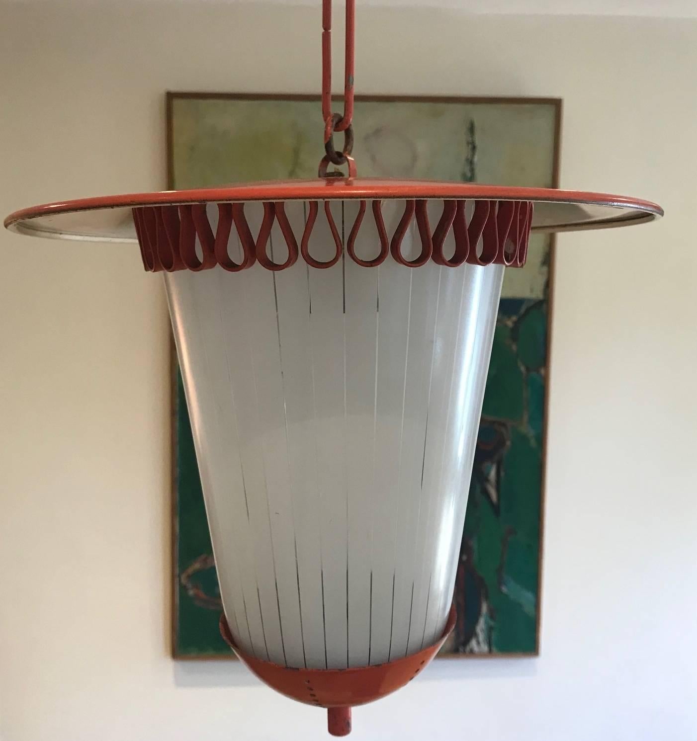 A red painted tole and opaline glass small hanging lantern or ceiling light or pendant in the style of Jean Royere, French, circa 1950s.
 