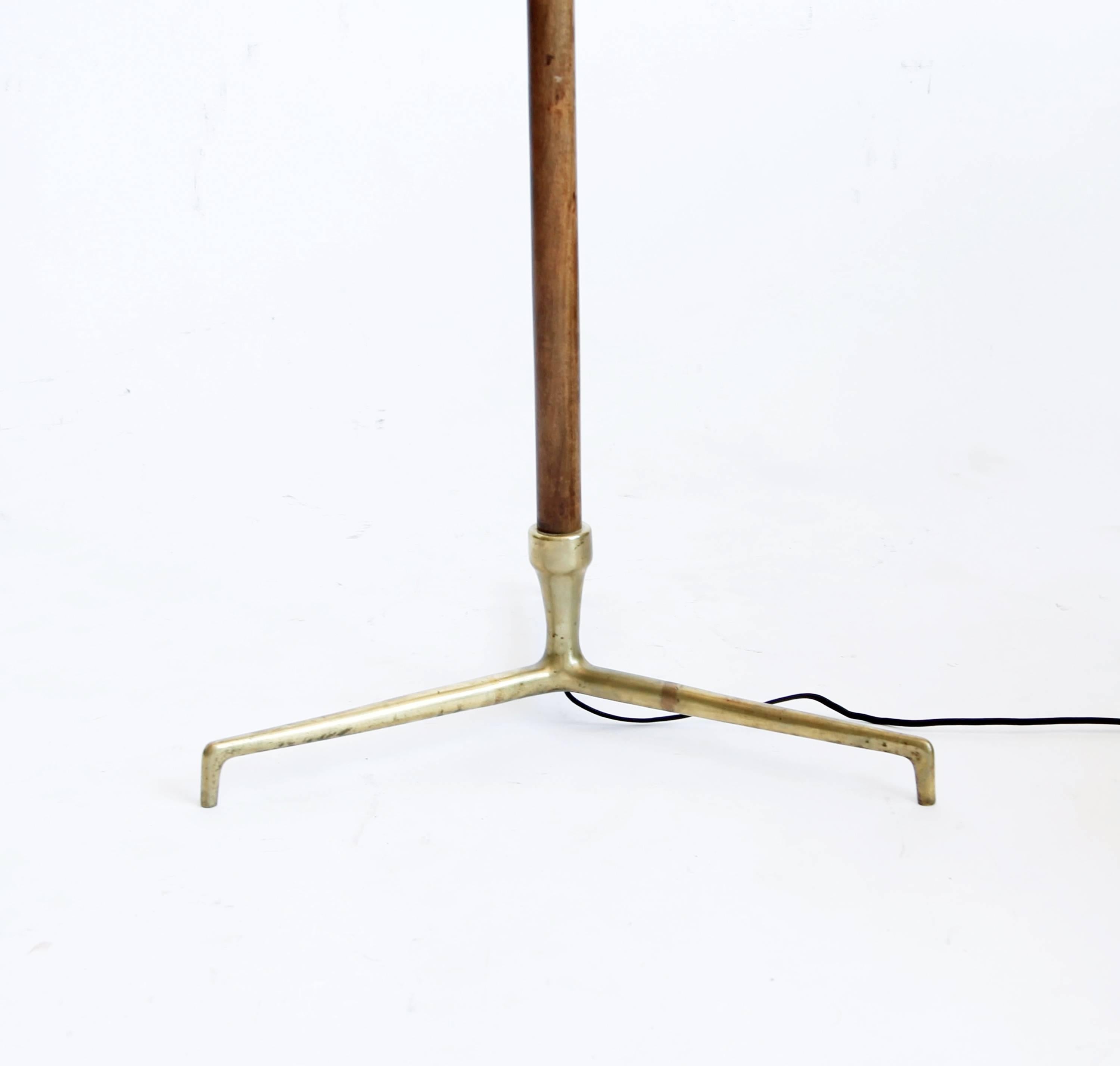 A lamp of substantial profile, with a tripod brass and walnut-encased base. The brass has a lovely patina. 

Rewired for U.S. depth does not include dimensions of shade.