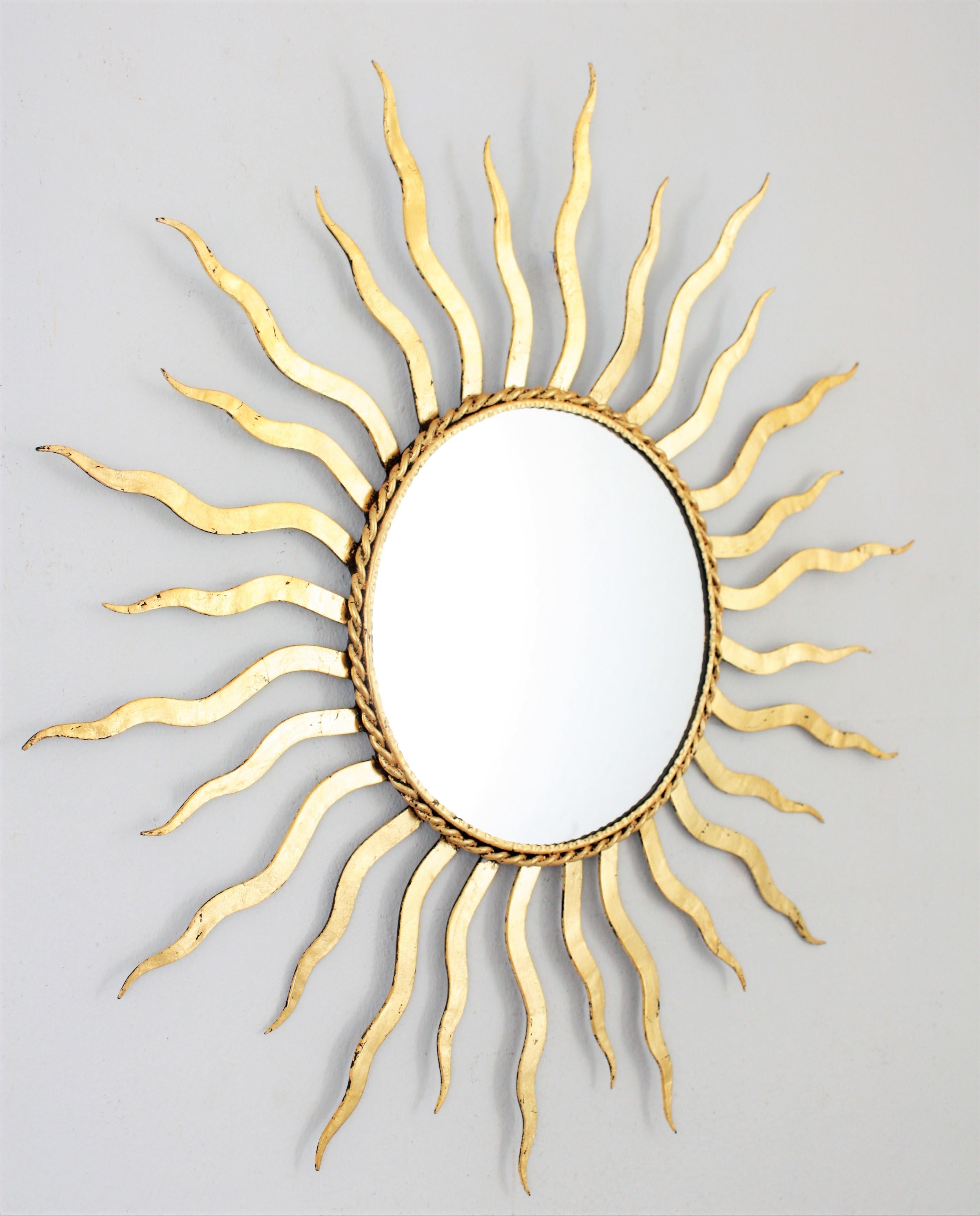 French 1950s Wrought Gilt Iron Sunburst Mirror in the Style of Gilbert Poillerat In Excellent Condition In Barcelona, ES