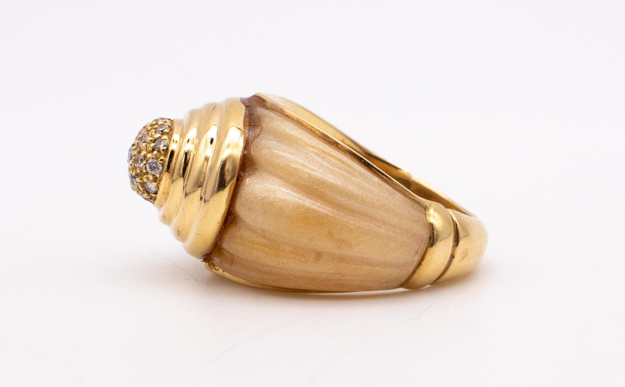 A French deco cocktail ring.

Beautiful piece, made in Paris France during the post-war period, circa 1960. This cocktail ring was crafted in yellow gold of 18 karats yellow and embellished with a fluted scalloped shank carved from amber
