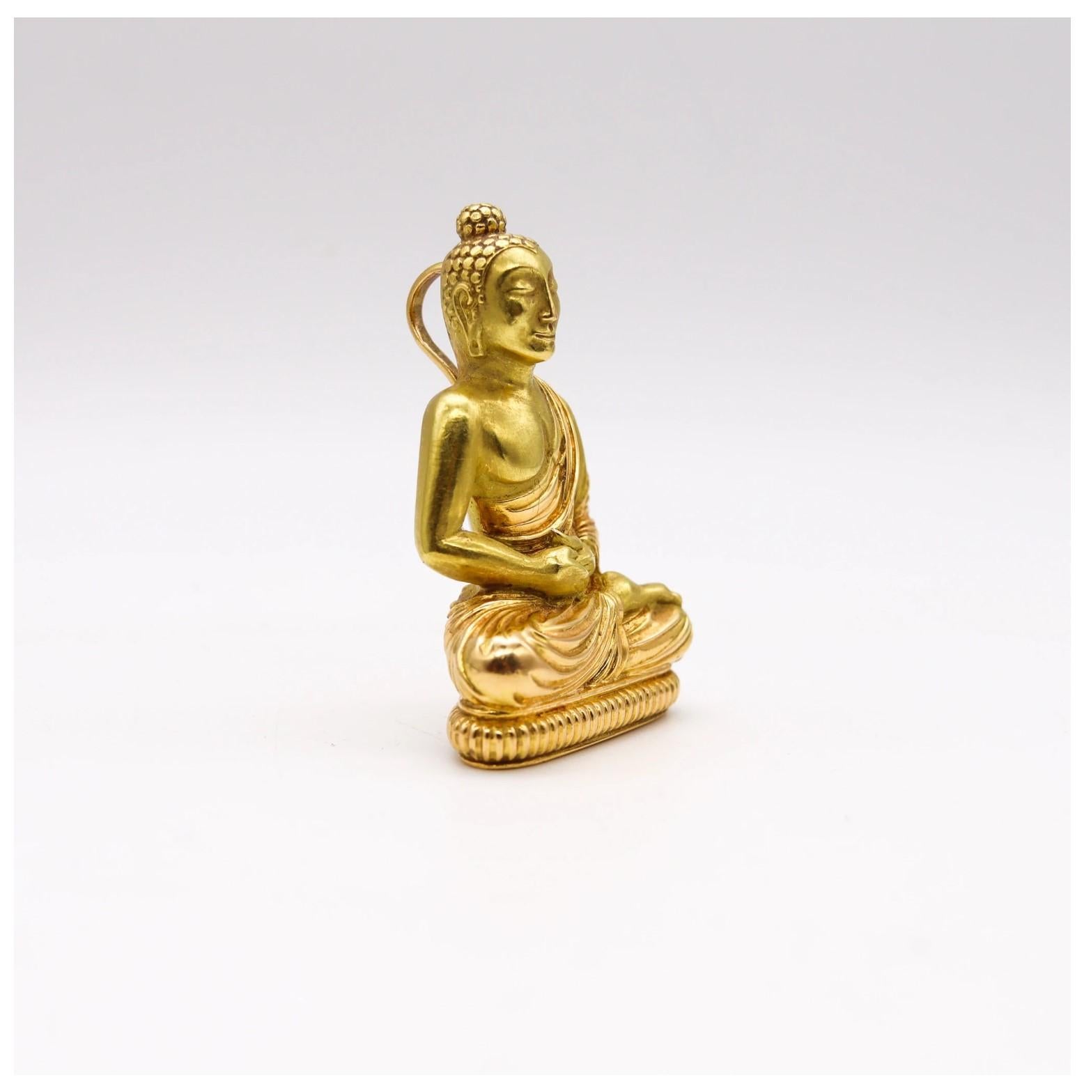 French pendant with a seated meditating Buddha.

Very unusual and elusive piece, created in Paris France, back in the early 1970's. This beautiful seated Buddha pendant has been carefully crafted in solid yellow gold of 18 karats, with brushed and