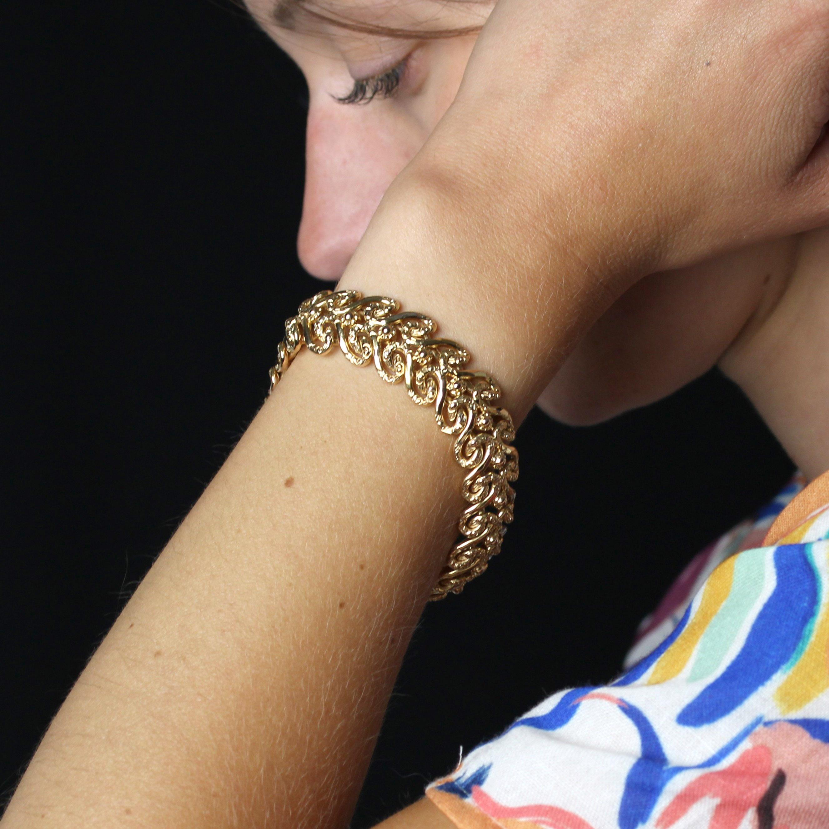 Armband aus 18 Karat Gelbgold, mit Adler und Nashornkopf gestempelt.
Dieses elegante Armband aus antikem Gelbgold zeichnet sich durch ein Netzmuster aus teilweise gravierten Arabesken aus, die ineinander verschlungene Motive zieren. Er hat einen