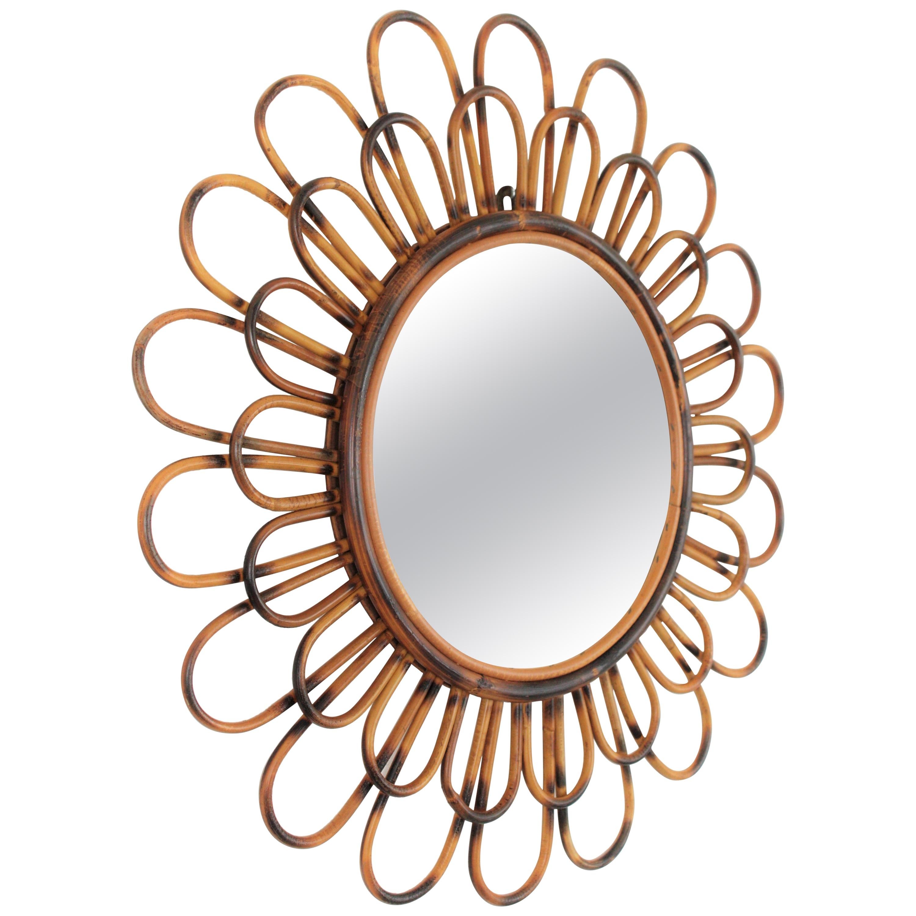 Double Layered Rattan Sunburst Flower Shaped Mirror. France, 1960s.
A lovely Mediterranean style handcrafted rattan flower shaped mirror with two layers of petals in two sizes and pyrography accents. It has all the taste from the French
