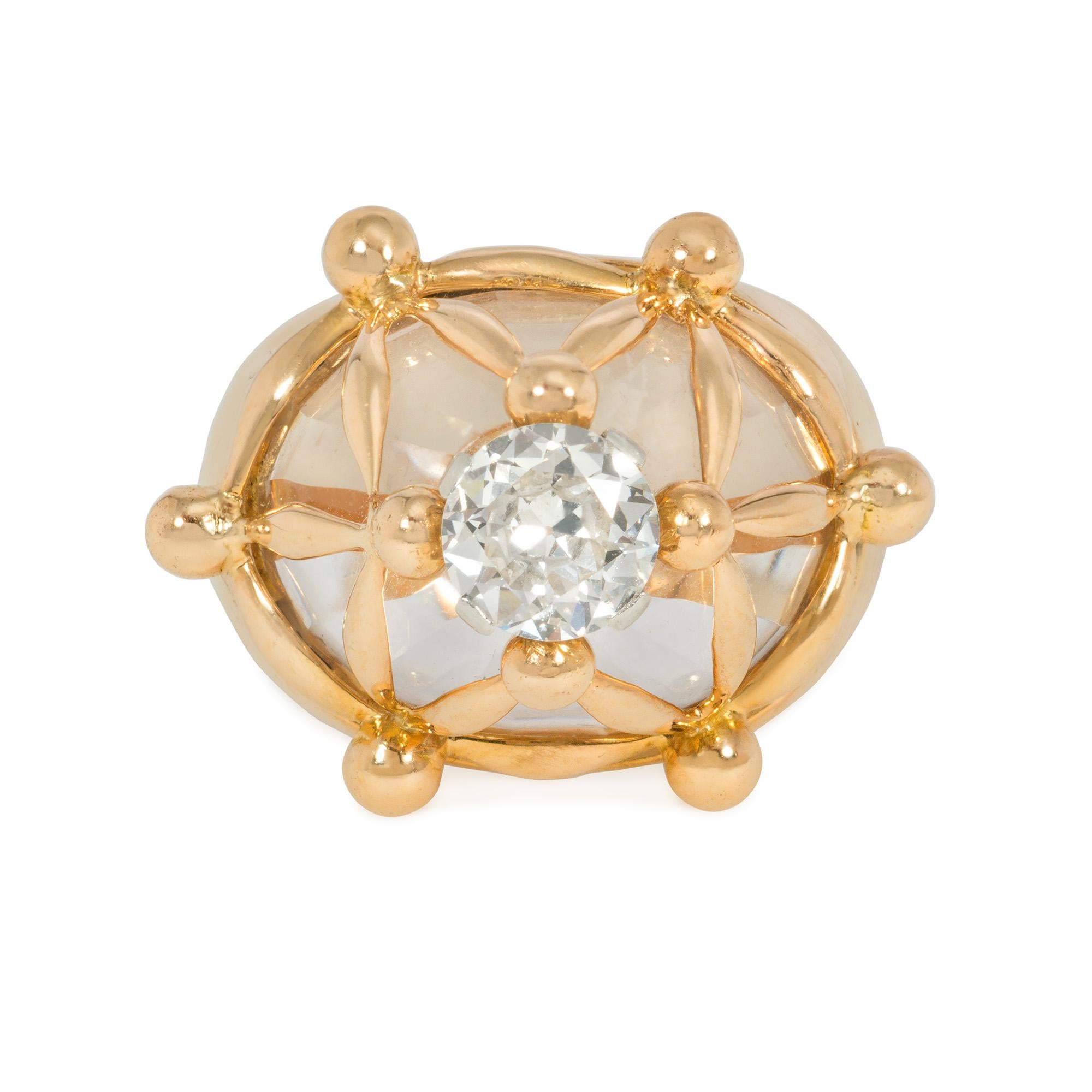 A Mid-Century bombé gold, rock crystal, and diamond ring, the carved rock crystal body centered by a prong-set, brilliant-cut diamond in an extruded gold matrix with bulbous ends, in 18k and platinum. Atw diamond 1.06 cts. France. Poinçon for