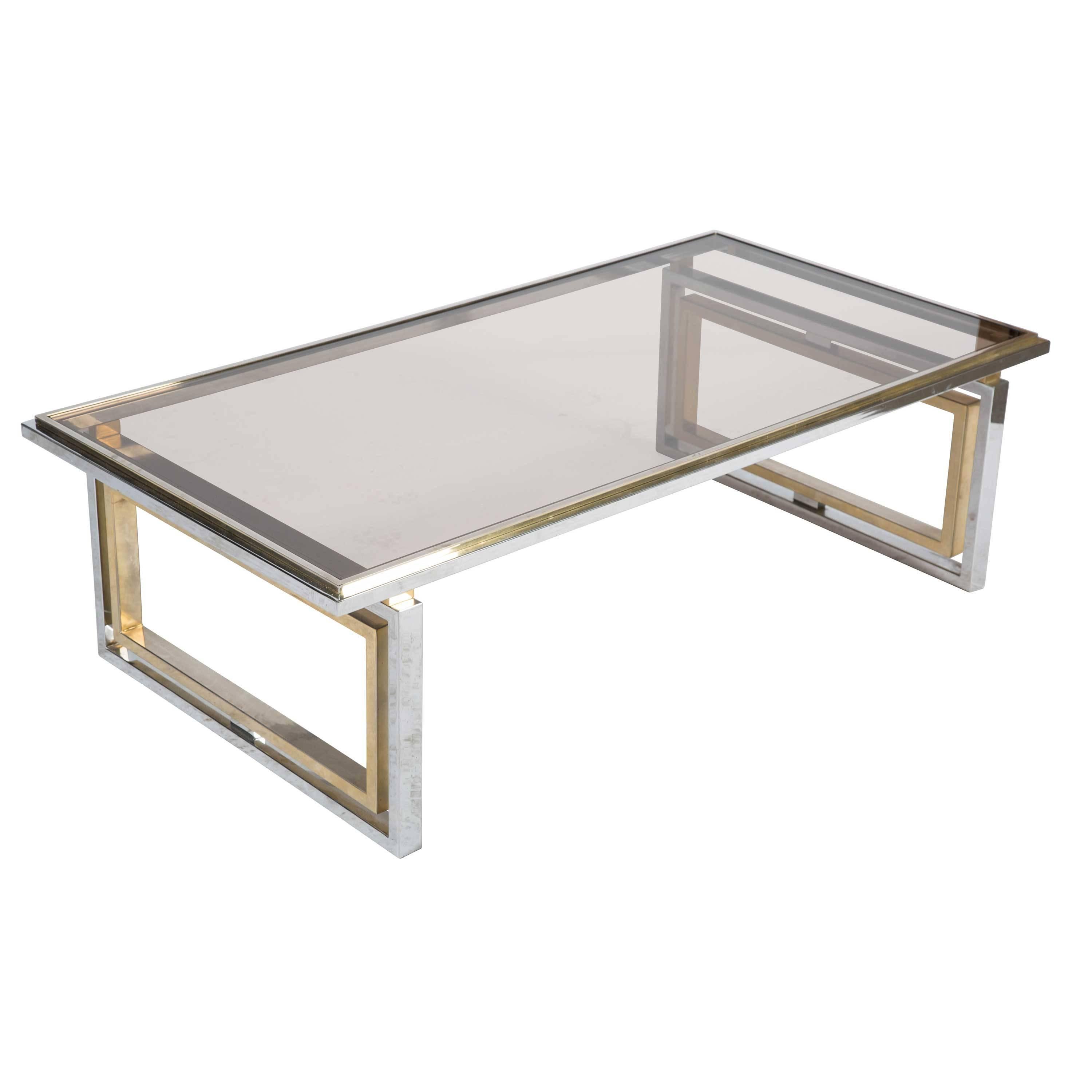 Chic and unusual French 1960s coffee table in brass and chrome, with an inset glass top.