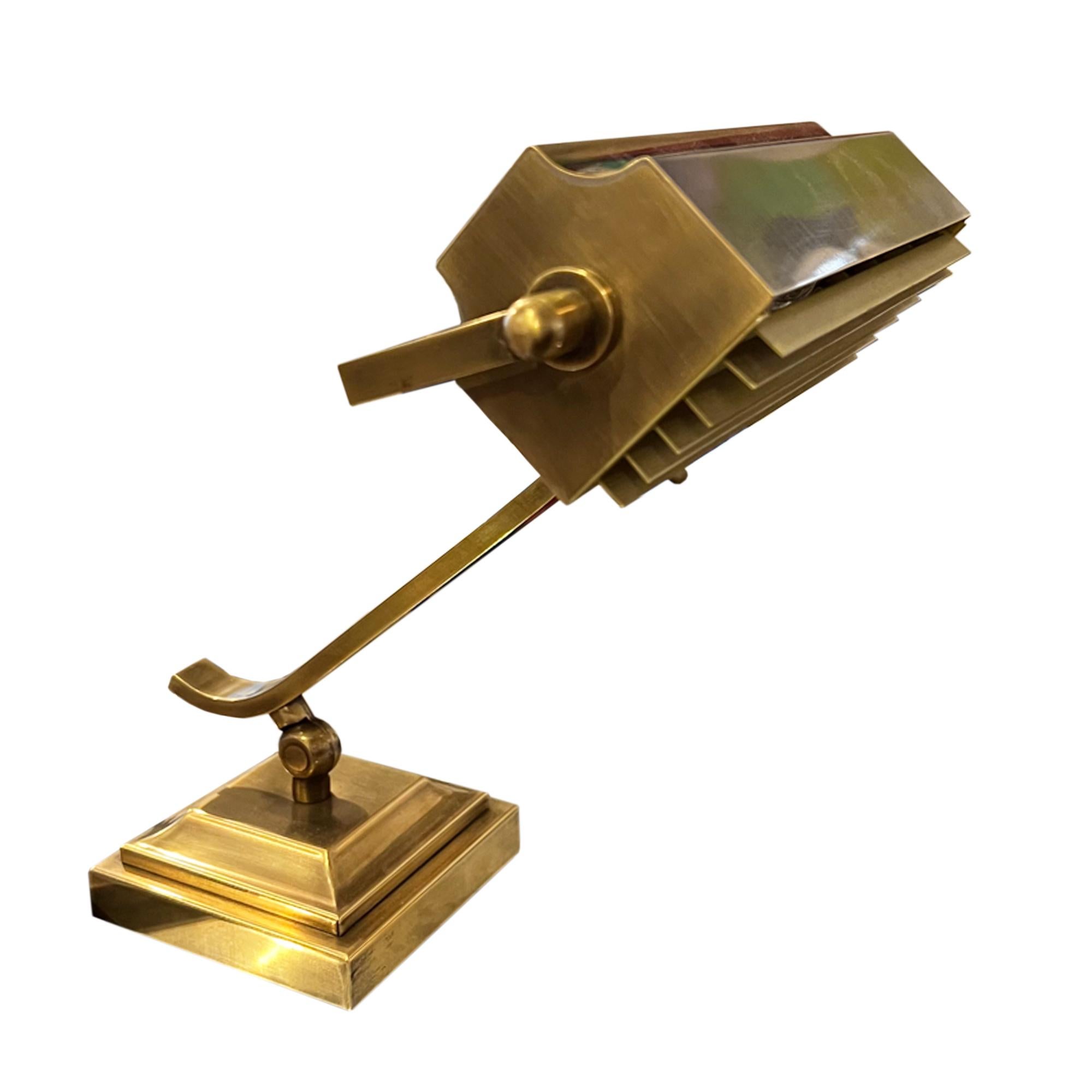 This is a traditional style banker's lamp made from brass with a  removable grill on the light. 

We've had this light rewired for the UK, we can easily change this for any destination - please just get in touch with any questions. It uses an E14