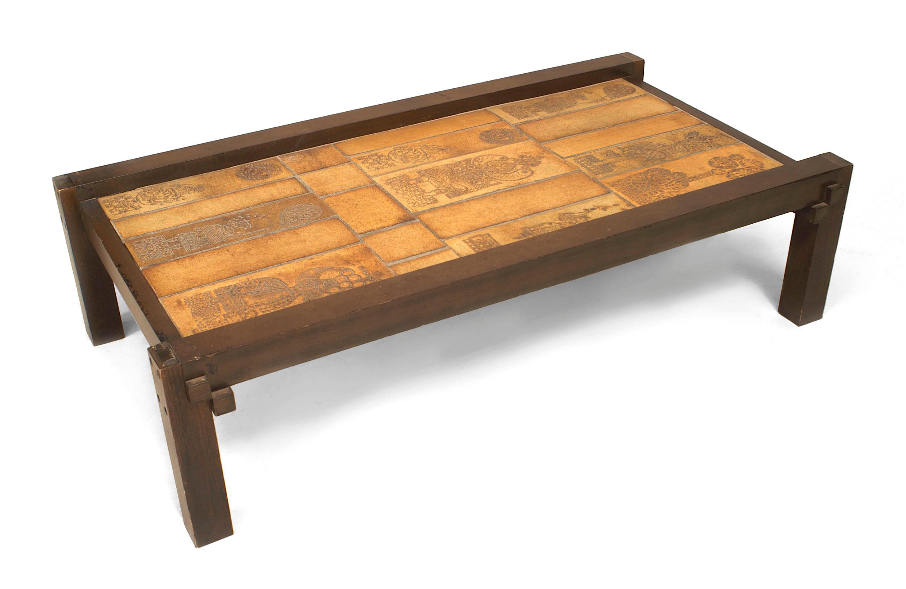French Mid-Century (1960s) rectangular coffee table with a brown painted wood frame supporting a ceramic tile top decorated with stylized figures. (signed: ROGER CAPRON)
