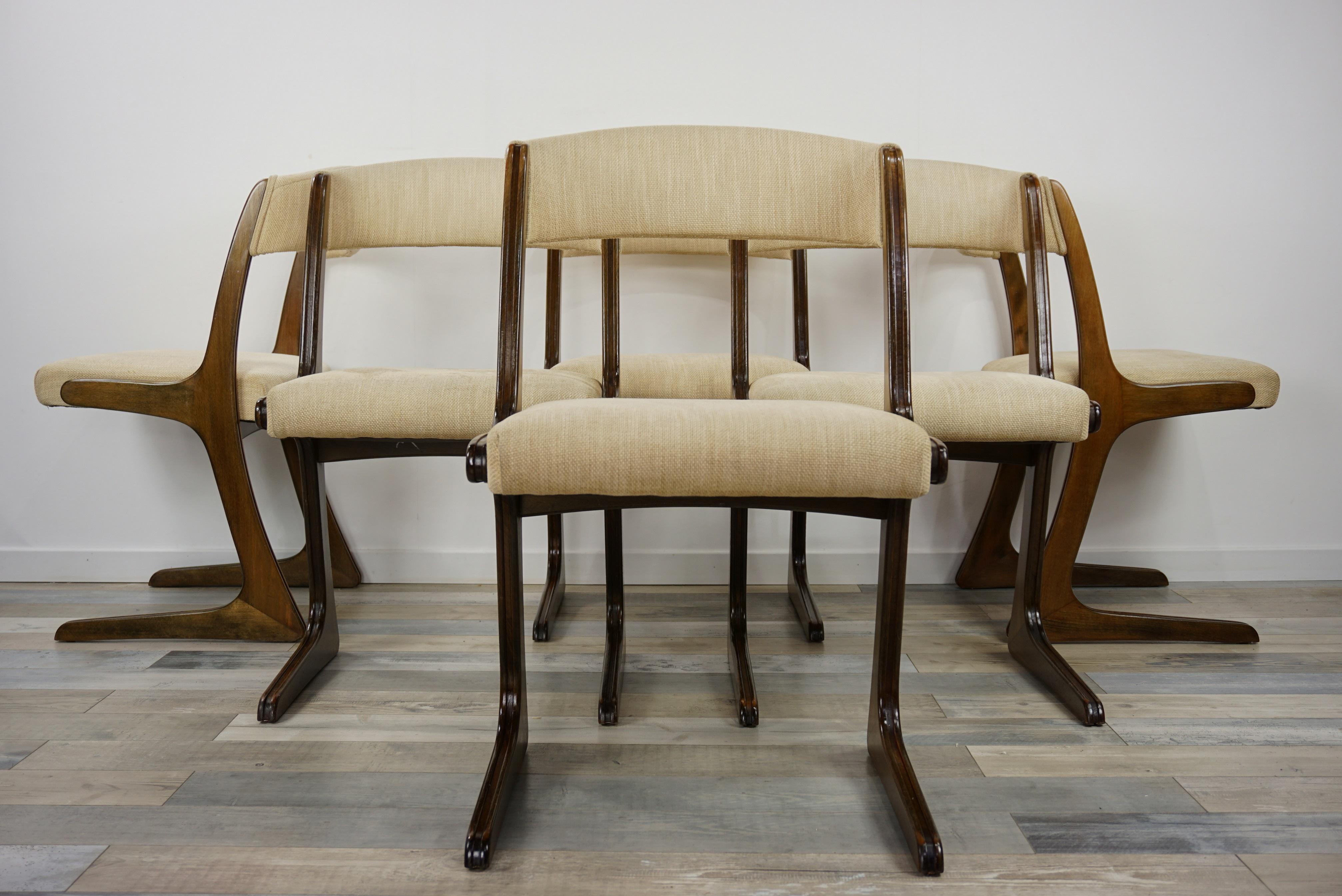 French 1960s design curved wooden and fabric set of six chairs composed of a sleg and outstanding wooden structure, a curved back and comfy seat.