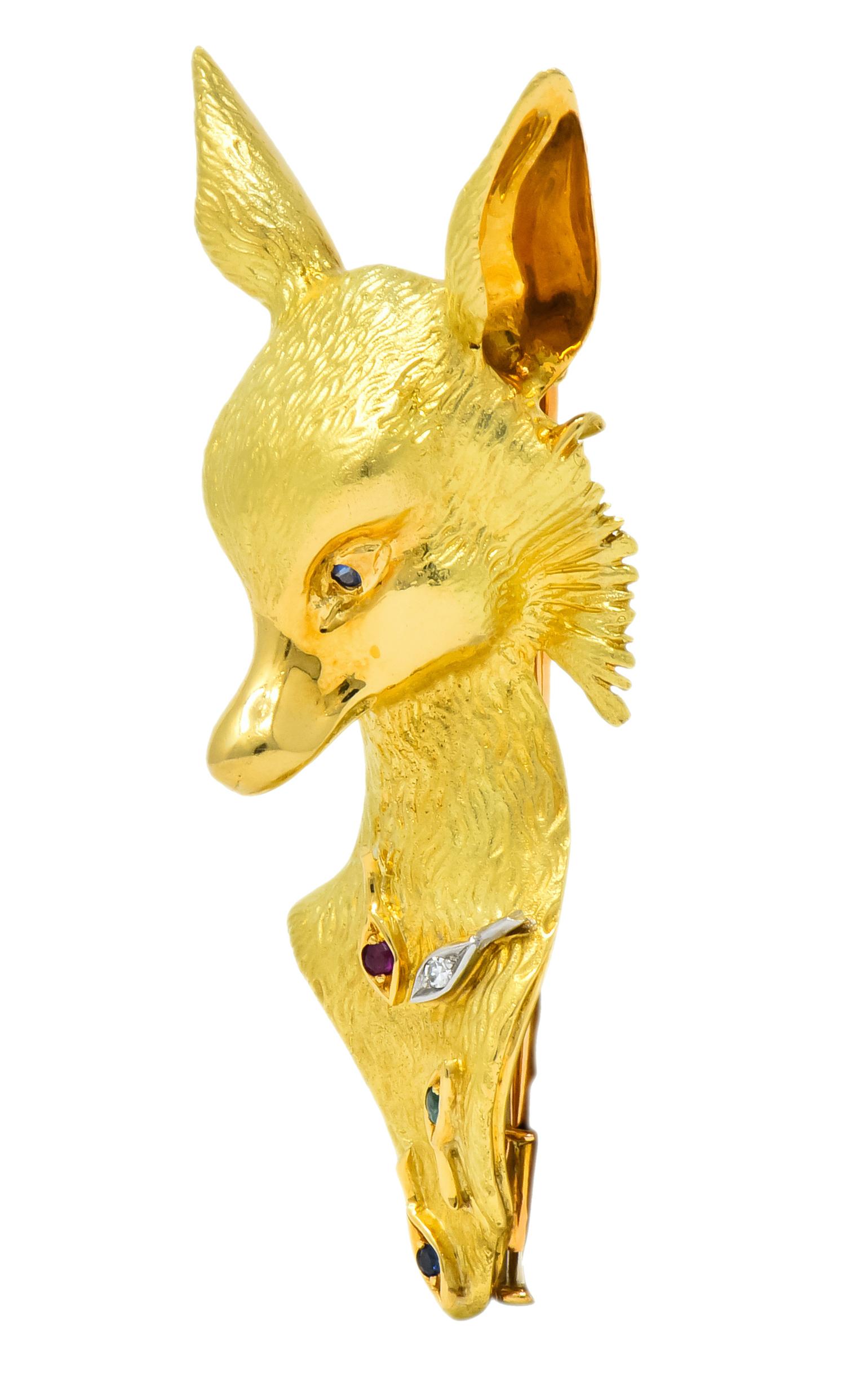 Designed as a sculpted fox with a textured gold finish as fur

Accented throughout by round cut ruby, emerald, sapphire, and single cut diamond

Completed by double pin stem and locking barrel closure

Tested as 18 karat gold

Circa 1960

Marked