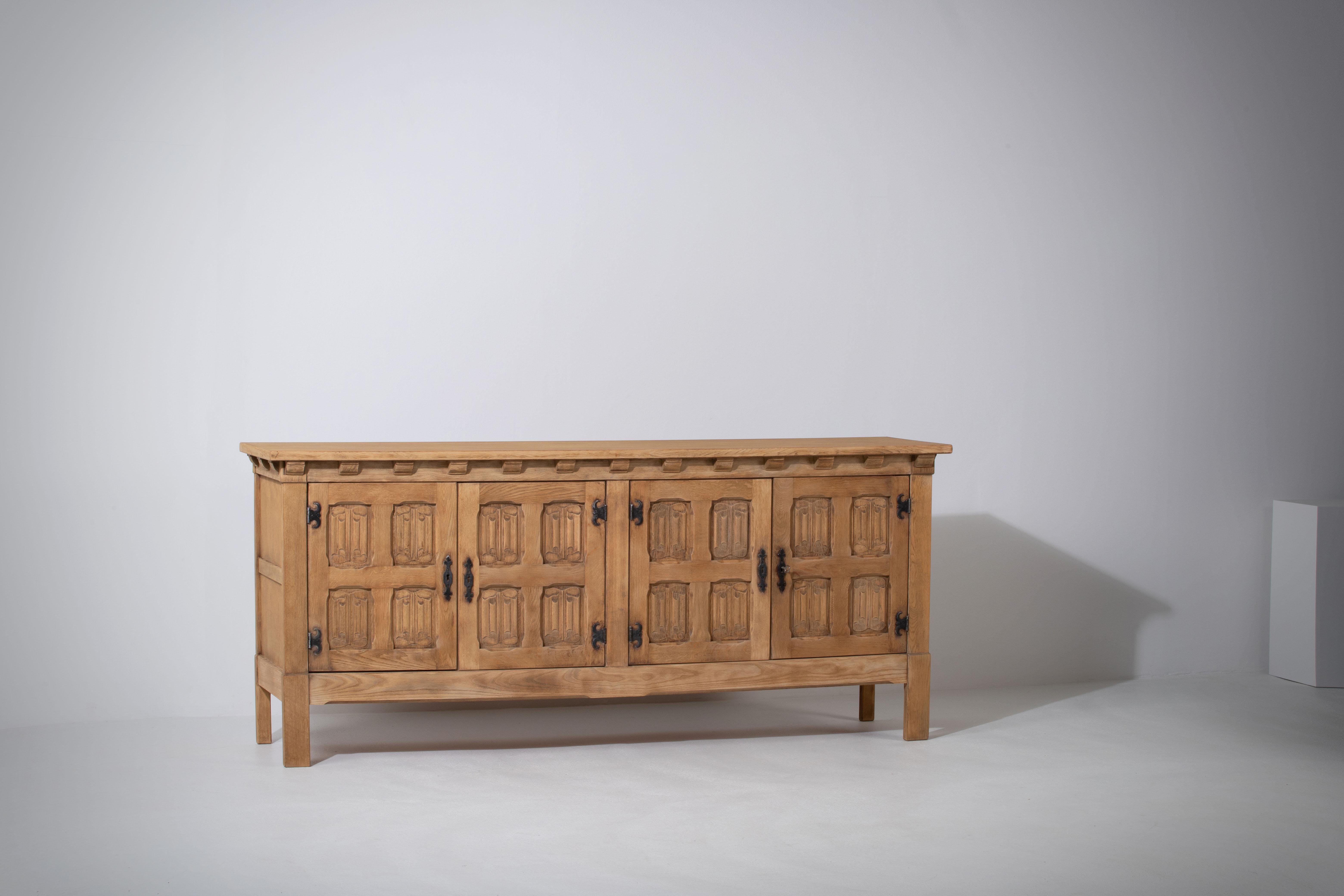Introducing a captivating solid elm sideboard, reminiscent of the celebrated work of French designer duo Guillerme et Chambron or the legendary Charlotte Perriand. This elegant cabinet effortlessly combines rustic country style with minimalism,