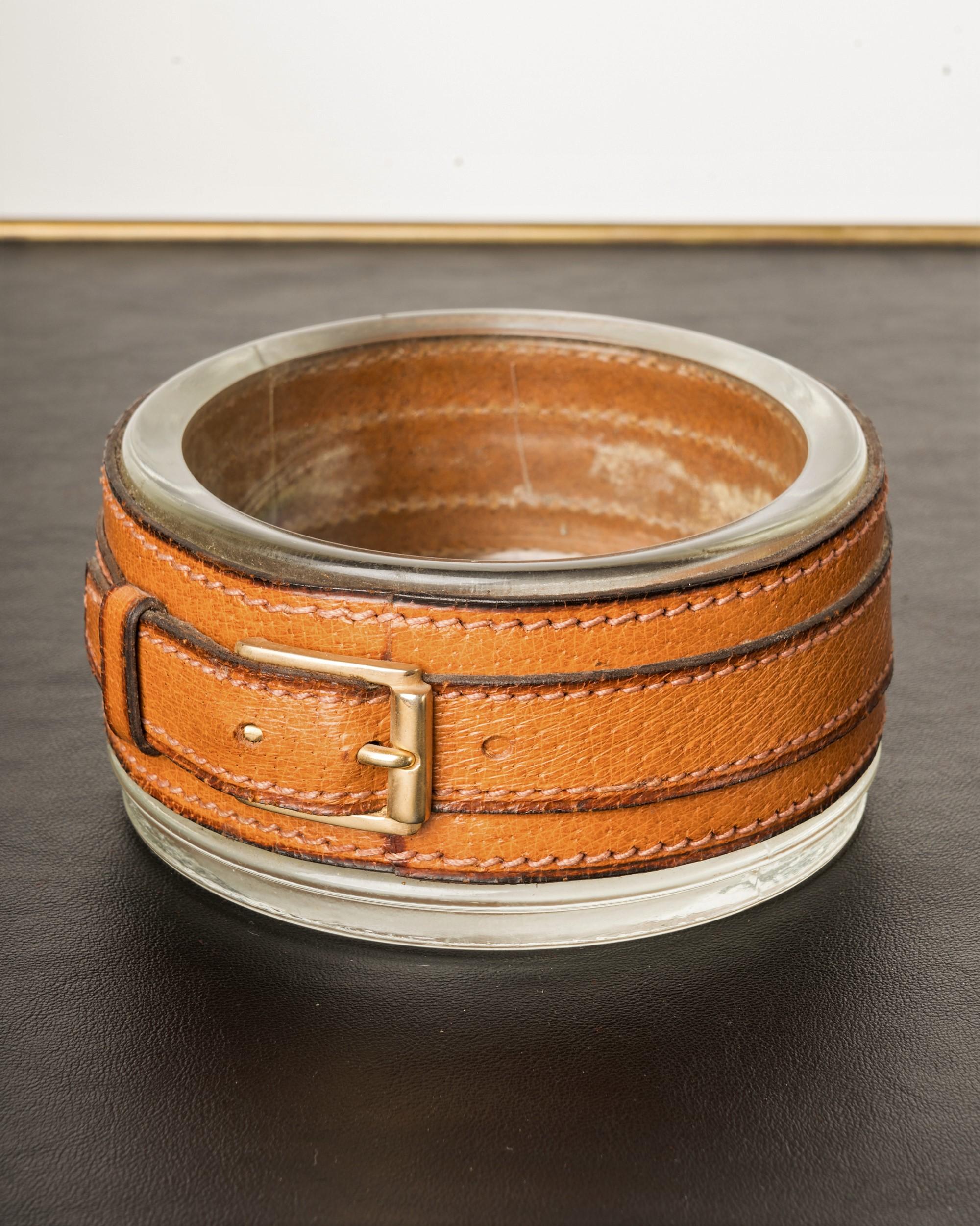 Handsome LUMAX thick glass vide-poche with a stitched Havana brown leather belt with a brass buckle. French 1960s, in very good vintage condition. The markings inside the dish are actually textures in the glass. Attributed to Jacques Adnet.