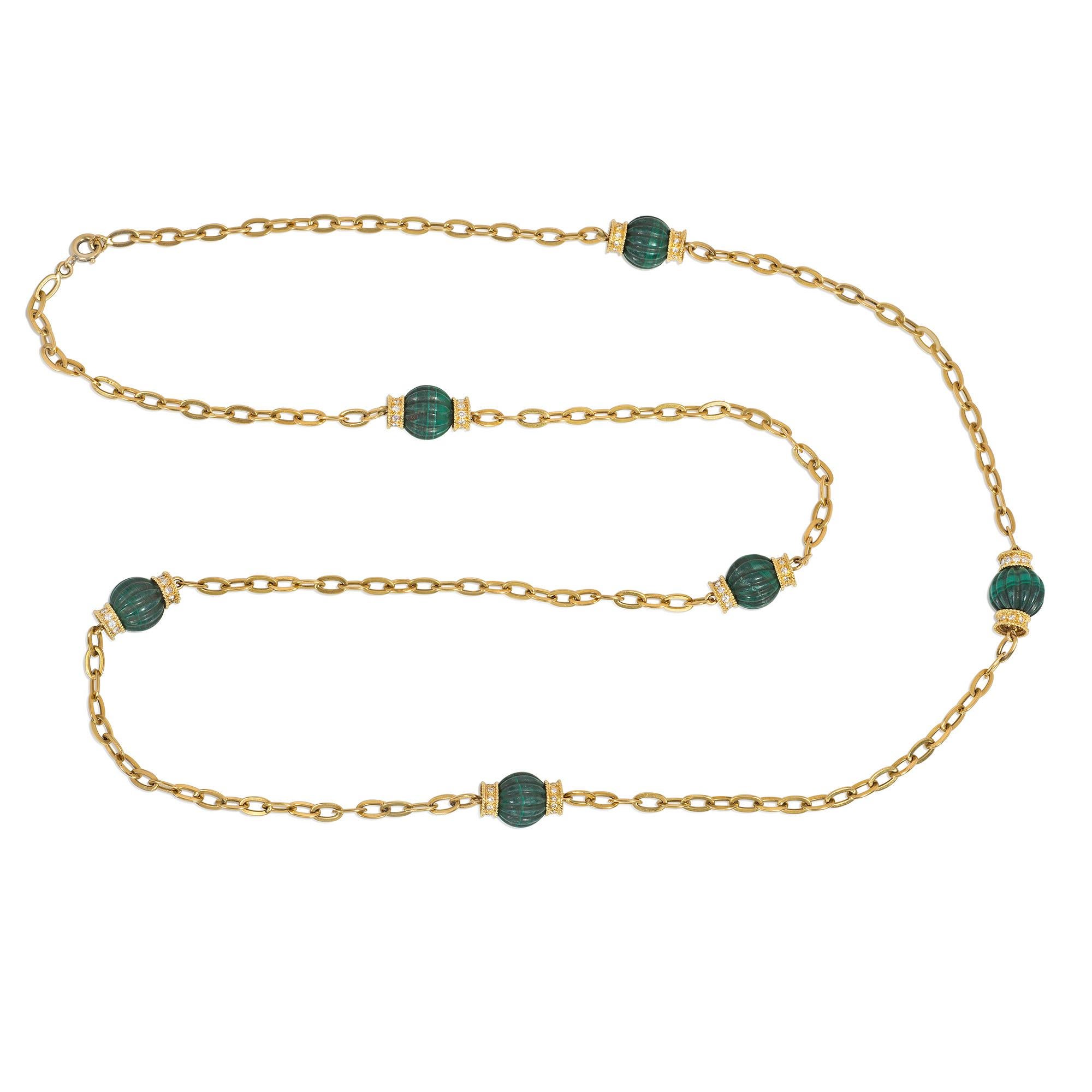 A mid-century gold, malachite, and diamond long chain necklace of cable links with carved malachite melon beads, each flanked by  diamond rondelles, in 18k with spring ring clasp, allowing the necklace to be worn doubled.  France.  Atw diamonds 2.40
