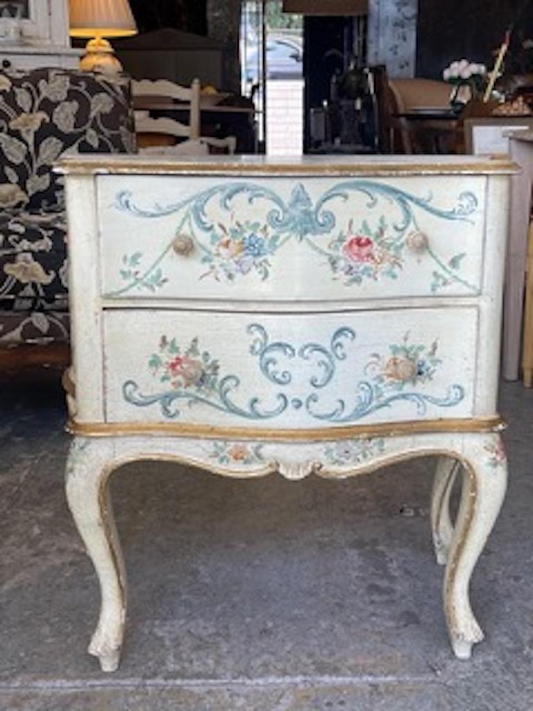 This is an unique example of decorative are work on furniture in the 1960s. This is a 2 drawer bow fronted small chest of drawers in the Louis XVI style with the cabroile shaped front and back legs.