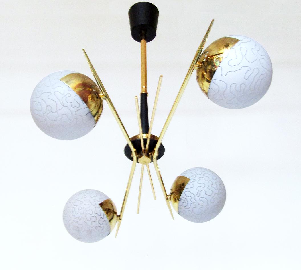 A 1960s 4-light Sputnik ceiling fixture in art glass and brass by French makers Maison Arlus.

The thick opal shades are strikingly etched. The brass starburst spikes evoke the excitement of the Space Age.

This light is in excellent condition.