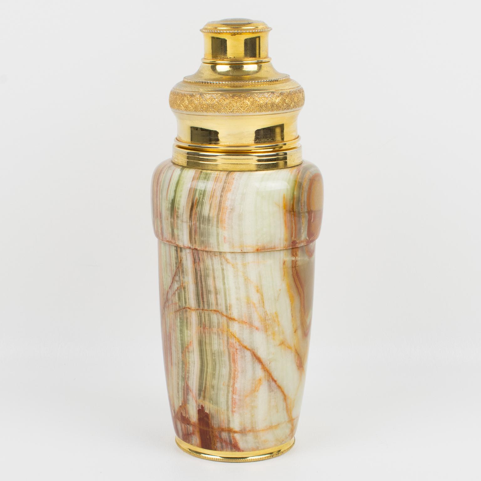 Stunning 1960s French gilded metal and onyx cylindrical cocktail or Martini shaker. Three-sectioned designed cocktail shaker with removable cap and strainer. Thick and heavy onyx stone container with changing pattern from all around. The cap and