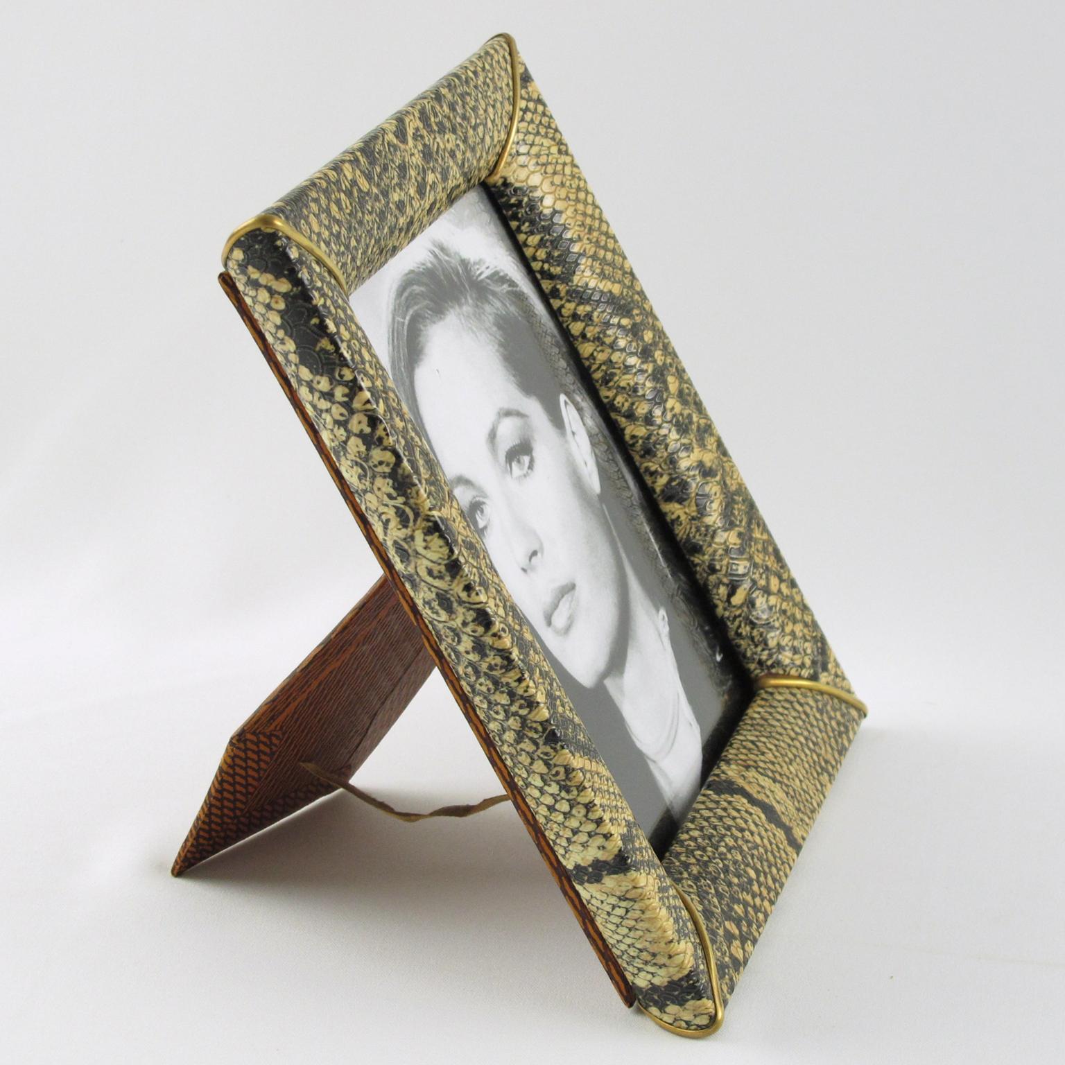 Lovely 1960s modern French picture photo frame. Decorative imitation leather or vinyl with faux python snakeskin textured pattern and brass accents. Easel at the back. The frame can be placed in a portrait or landscape