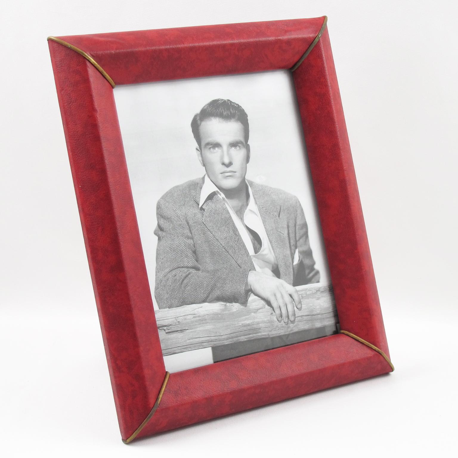 Lovely 1960s French picture photo frame. Decorative imitation leather (vinyl) with textured pattern in red and black marble color and brass corner accents. Back and easel in decorative paper. The frame can be placed in portrait or landscape