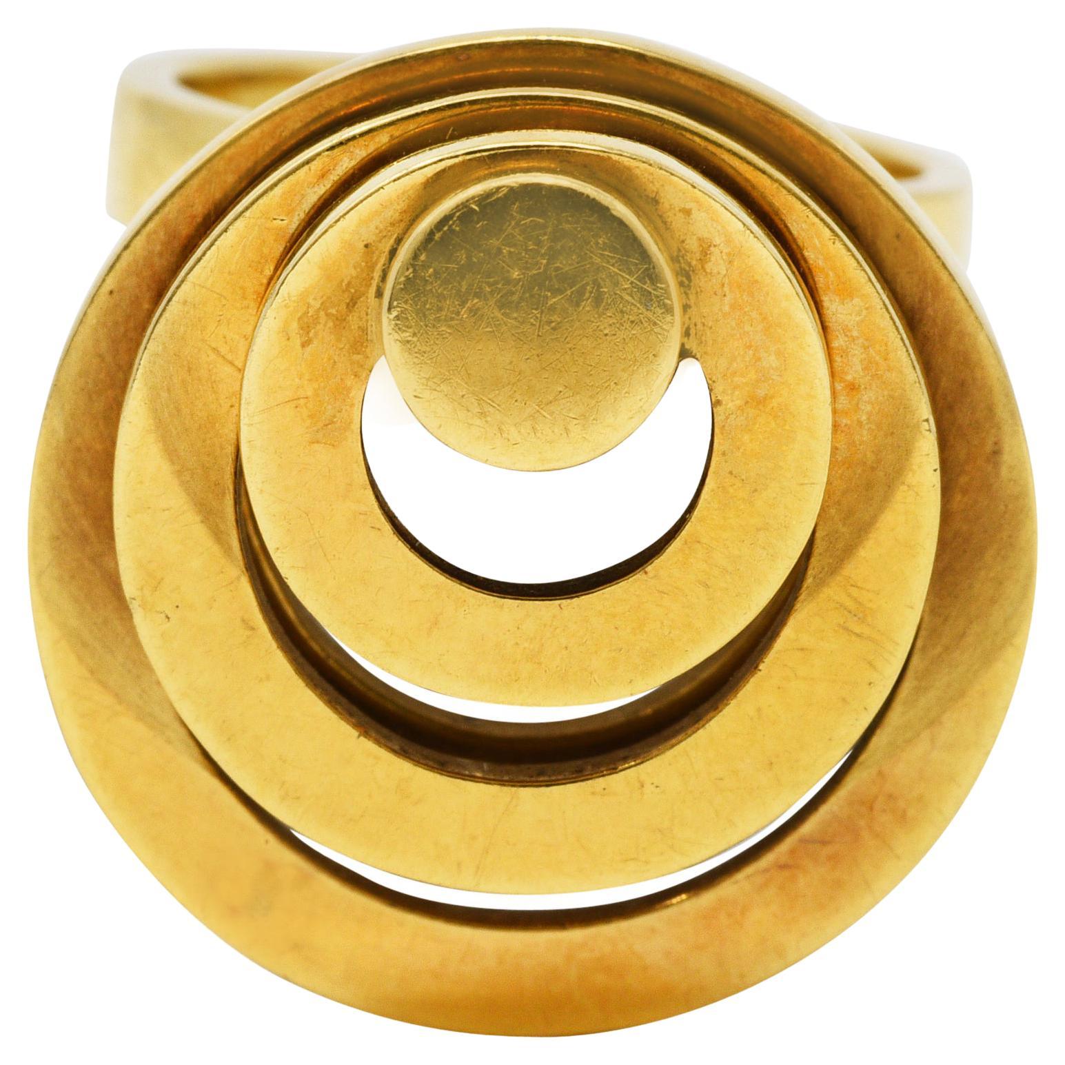 Ring designed as geometric stacked motion ring 

Featuring five tiered circles of varying sizes that spin around a central point

Completed by simple band shank

With French assay marks for 18 karat gold

With maker's mark

Circa: 1960's 

Ring