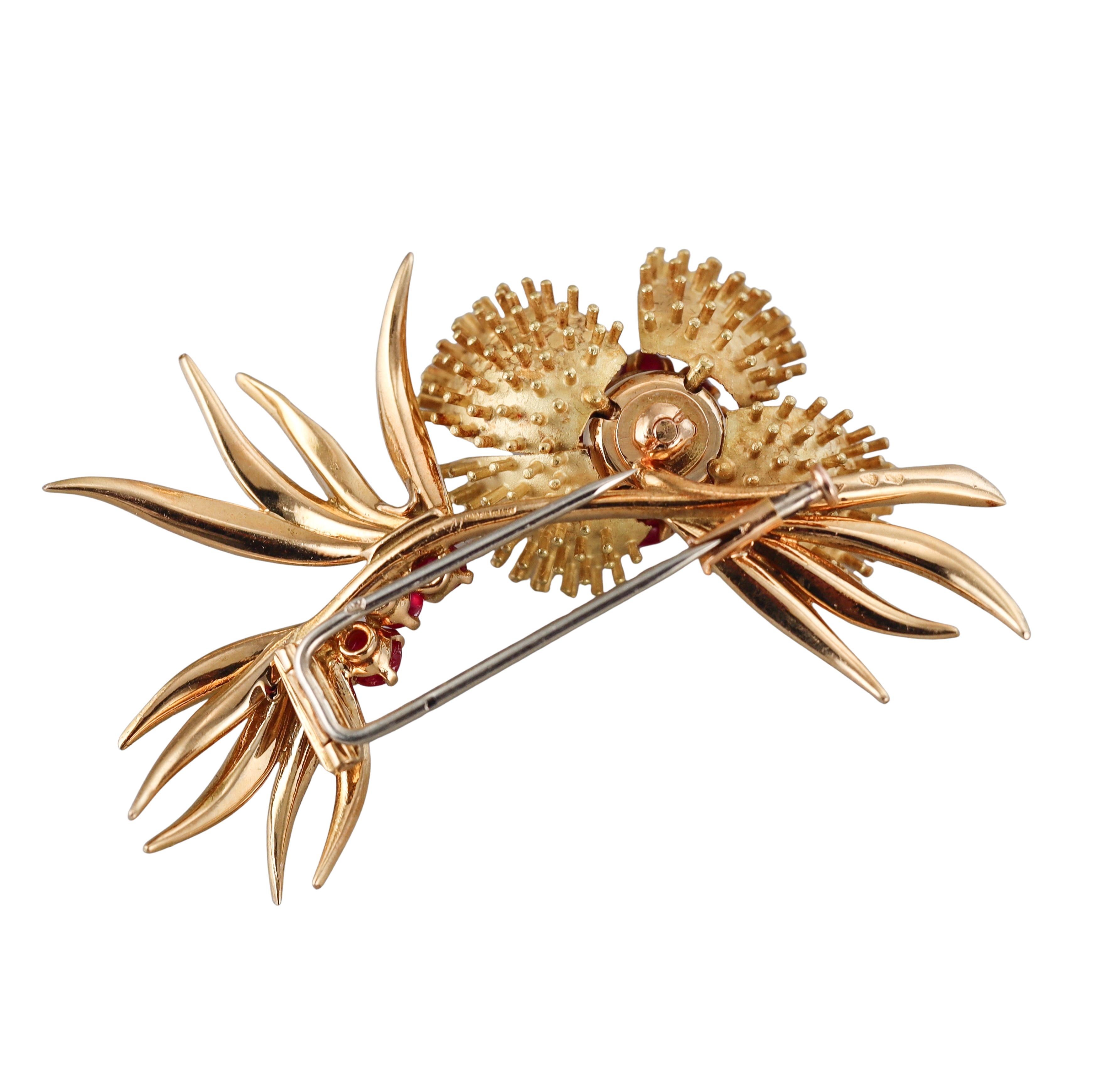 French made circa 1960s 18k yellow gold brooch with ruby cabochons, depicting a flower. The flower petals open and close. Brooch is 2.25